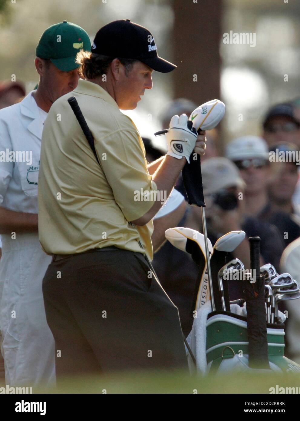 Phil Mickelson of the U.S. (C) marks one of his two drivers as caddie Jim 'Bones' MacKay watches as he prepares to drive on the fourth hole during a practice round for the 2006 Masters Golf Tournament at the Augusta National Golf Club in Augusta, Georgia, April 4, 2006. Mickelson has chosen to carry two drivers in the tournament, one to draw and one to fade and to leave out a sand wedge. Play in the tournament begins Thursday. Mickelson is a former Masters champion.     REUTERS/Robert Galbraith Stock Photo
