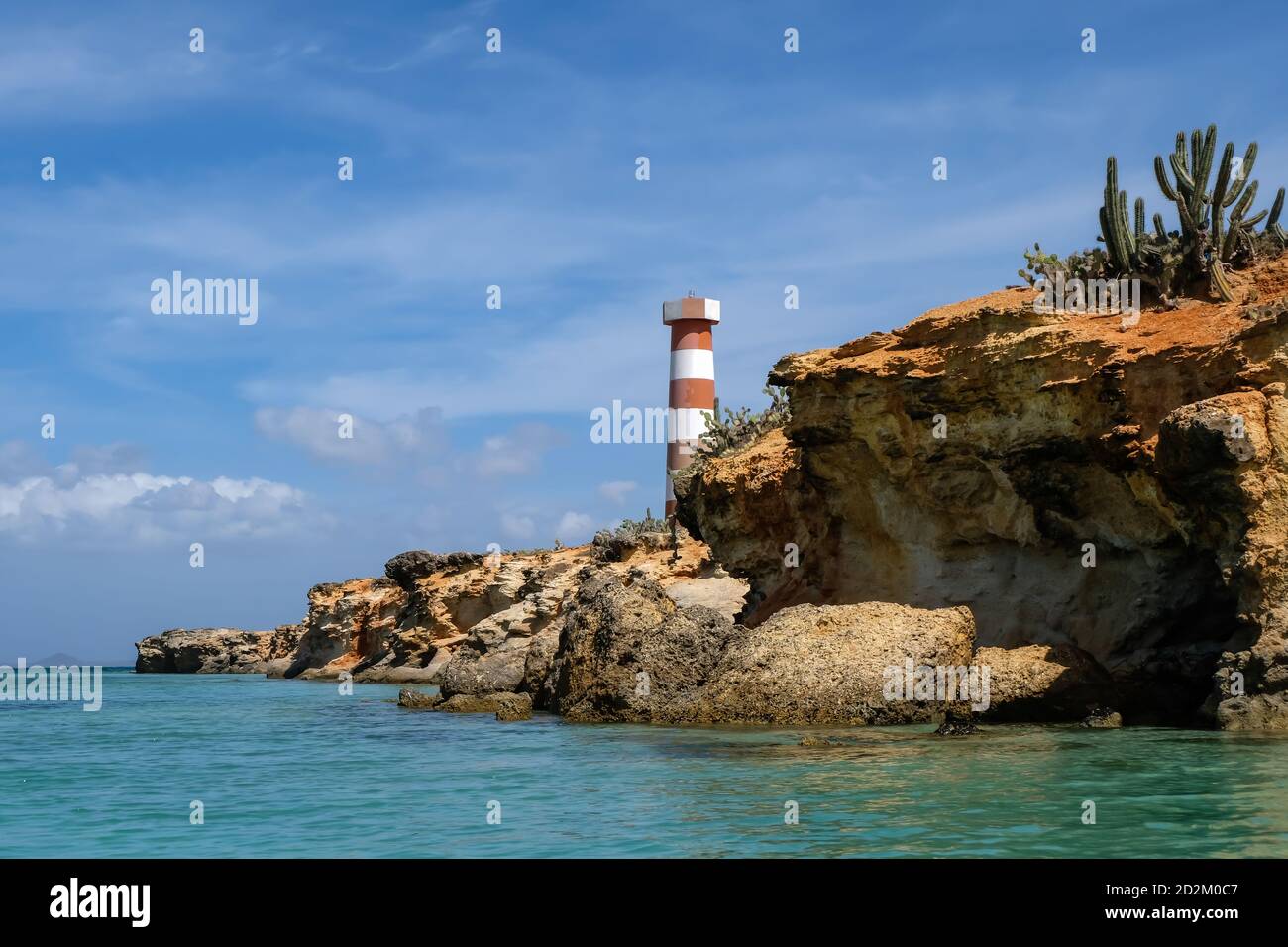 Coast seascape with rocks and a light house in Cubagua island (Venezuela). Stock Photo