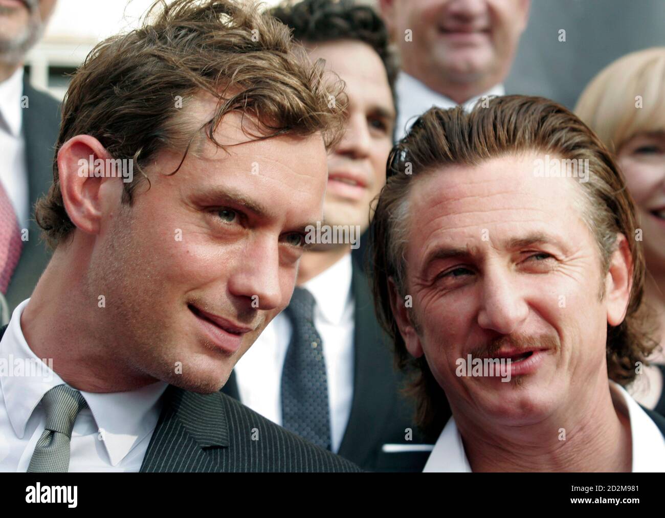 Cast members Jude Law (L) and Sean Penn talk as they pose for photos at the  premiere of "All the King's Men" in New Orleans, Louisiana September 16,  2006. REUTERS/Lee Celano (UNITED