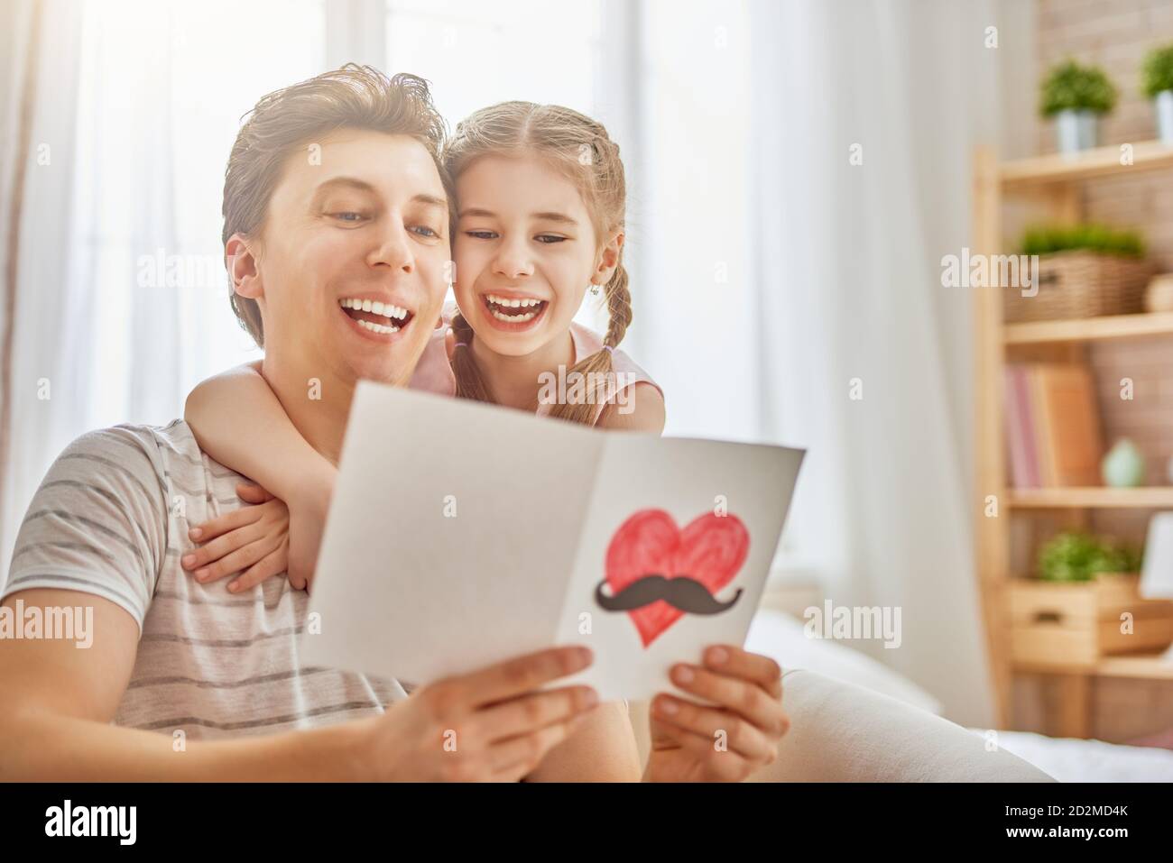 Happy father's day! Child daughter congratulates dad and gives him ...
