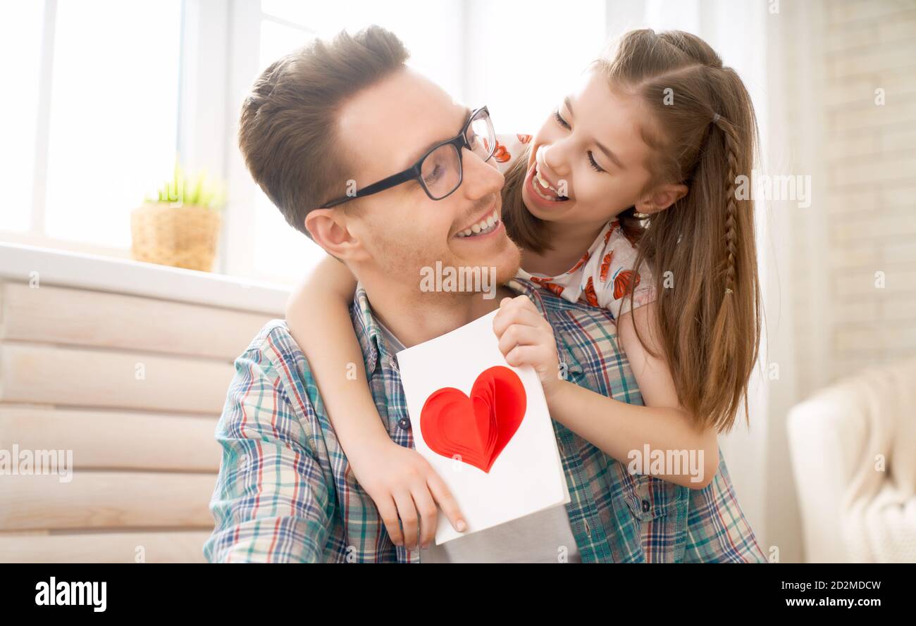 Happy father's day! Child daughter congratulating dad and giving him ...