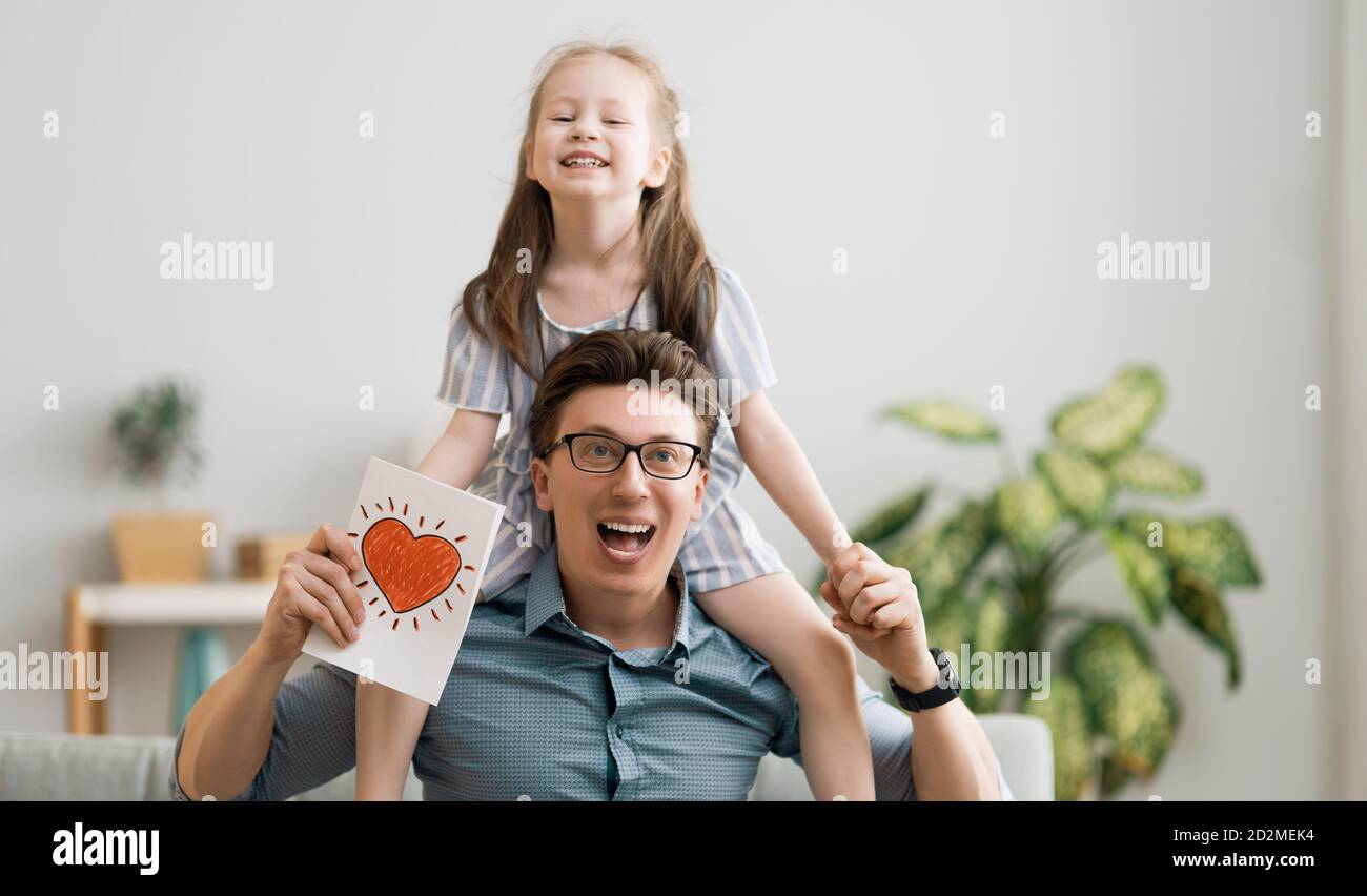 Happy father's day! Child daughter congratulating dad and giving him ...