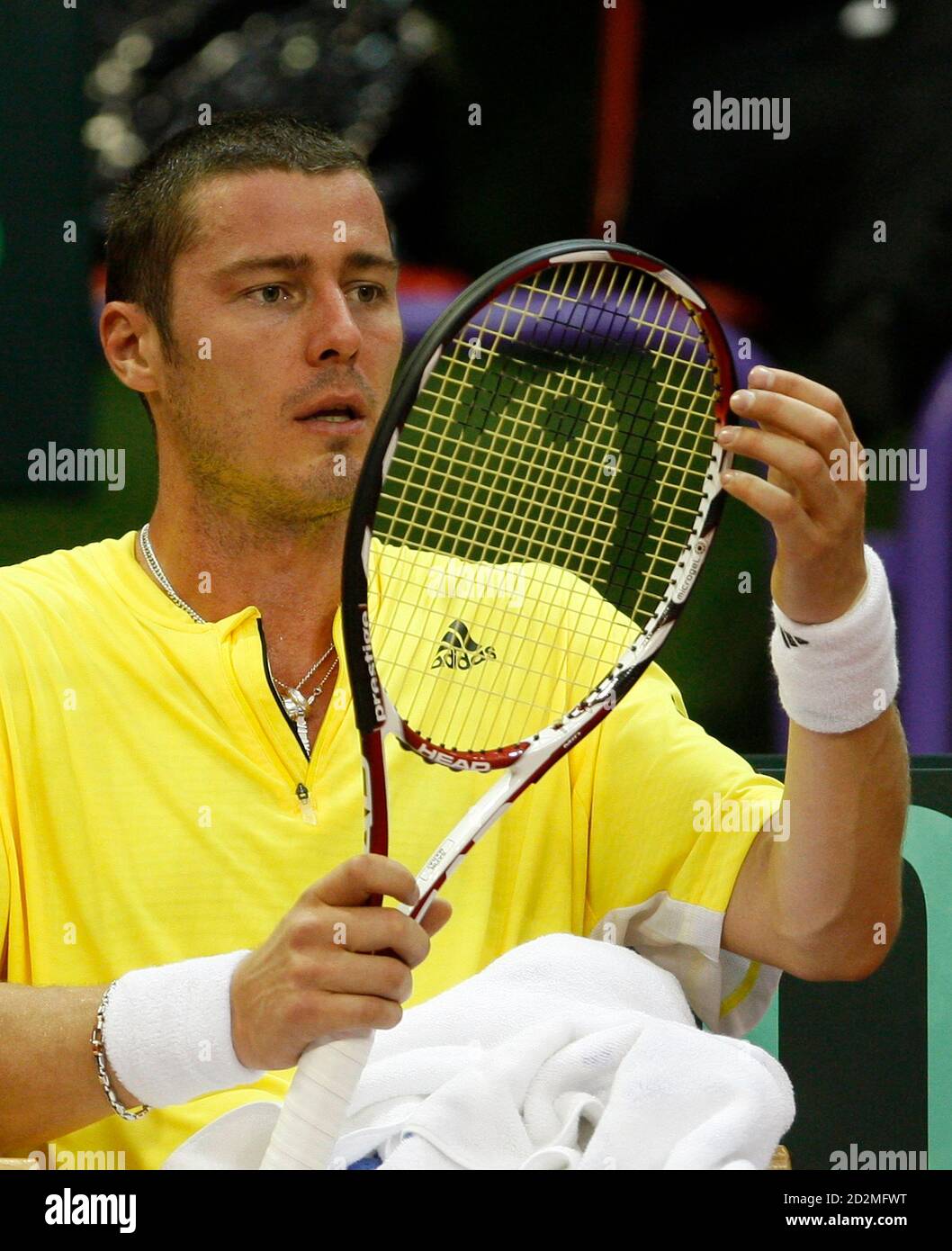 Marat Safin of Russia looks at his racket during his first round World  Group Davis Cup tennis match against Victor Crivoi of Romania in Sibiu,  March 6, 2009. REUTERS/Radu Sigheti (ROMANIA Stock