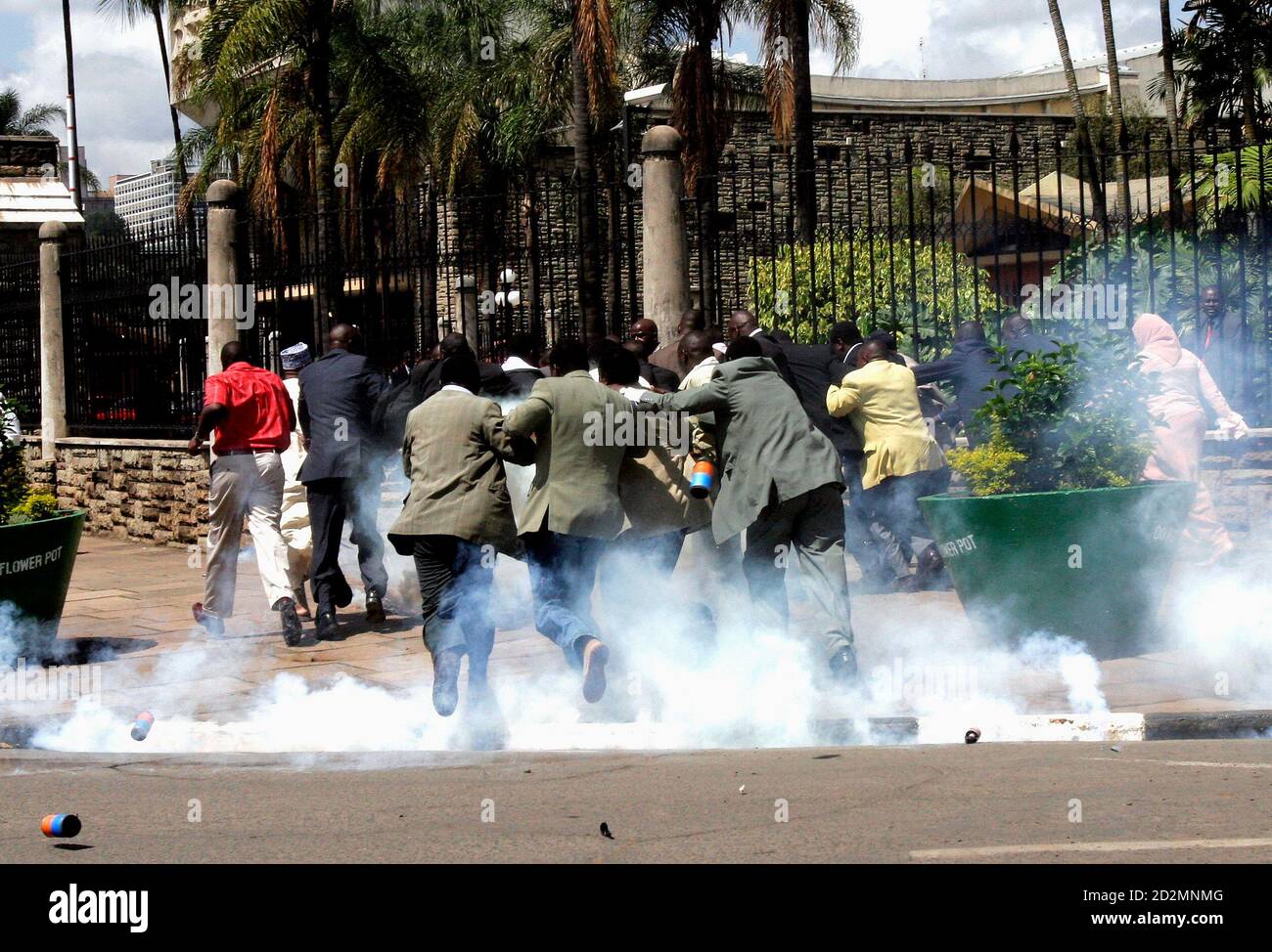 Kenya's opposition leaders run to parliament buildings during a political protest in Nairobi December 5, 2006. Kenya police on Tuesday tear-gassed opposition leaders and backers protesting a government-approved change to the former ruling party's leadership viewed by many as a political coup. REUTERS/Thomas Mukoya (KENYA) Stock Photo