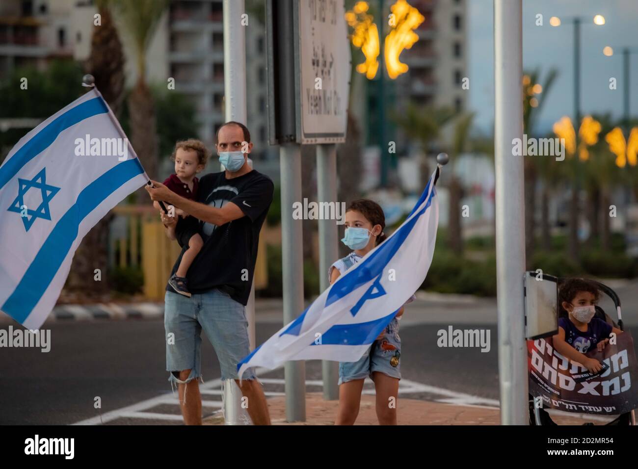 Protesters,protes,demonstration,protest,protesting,crimes,crime minister,crime,bribe,bribery,bloated,government,corruption,mis management,mismanagement,dictatorship,dictator,state,Prime Minister,Benjamin,Bibi,Netanyahu,Israel,Israeli,2020,middle east,patriot,patriots,black flag movement,demonstrator,demonstrators,people,placard,protester,flag,freedom,protection,banner,activist,patriotic,activism,public,national,political,country,rally,movement,culture,mask,democracy,action,holding,politics,woman,march,crisis,protests Stock Photo