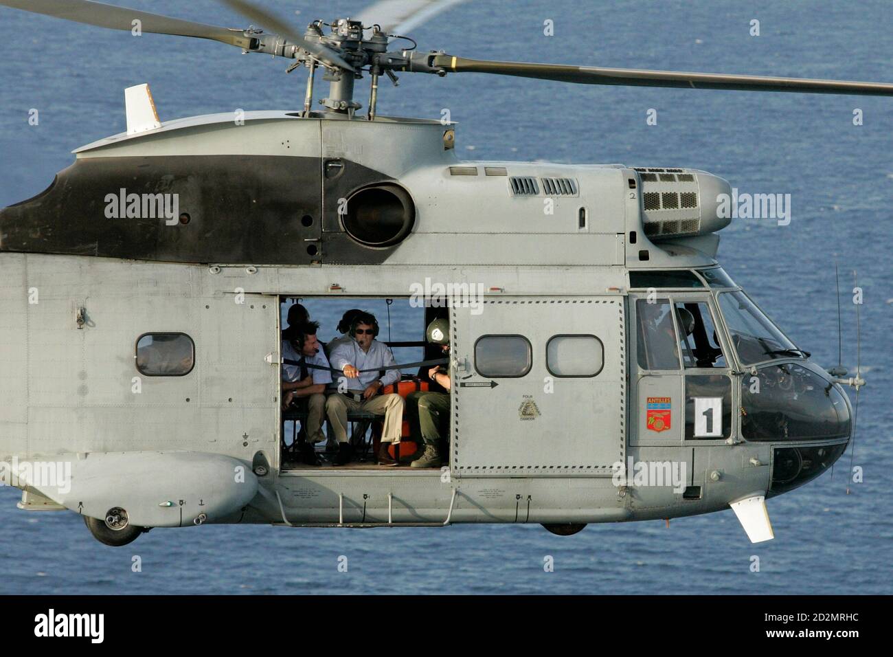 France's Prime Minister Francois Fillon (C) flies over the sea in  Terre-de-Haut in a helicopter as he visits the French Caribbean island of  Guadeloupe August 22, 2007. Hurricane Dean destroyed all of