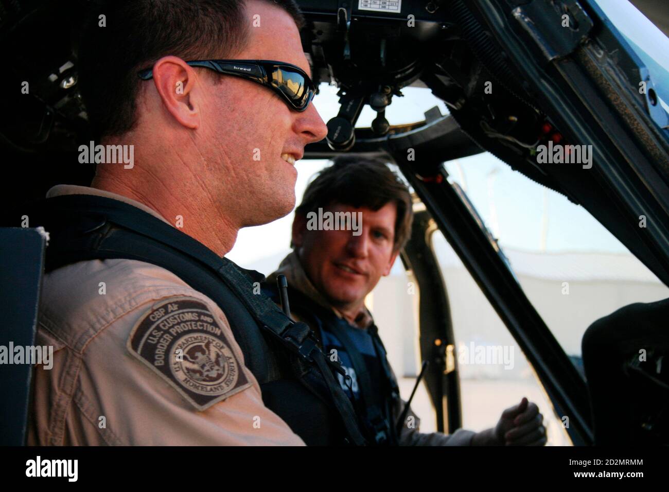 U.S. Customs and Border Protection pilots Wade Koontz (L) and Rich Rouviere ready a Black Hawk helicopter for a mission south of Tucson, Arizona, August 21, 2007. Crews in the fast military helicopters work closely with the CBP Predator B spy drones, in a pioneering program to spot and arrest drug traffickers and illegal immigrants crossing the desert from Mexico. The program is to be extended to parts of the northern border with Canada and the U.S. Gulf coast in coming months.      To match feature USA-IMMIGRATION/BLACKHAWKS  Picture taken August 21, 2007.  REUTERS/Tim Gaynor     (UNITED STAT Stock Photo