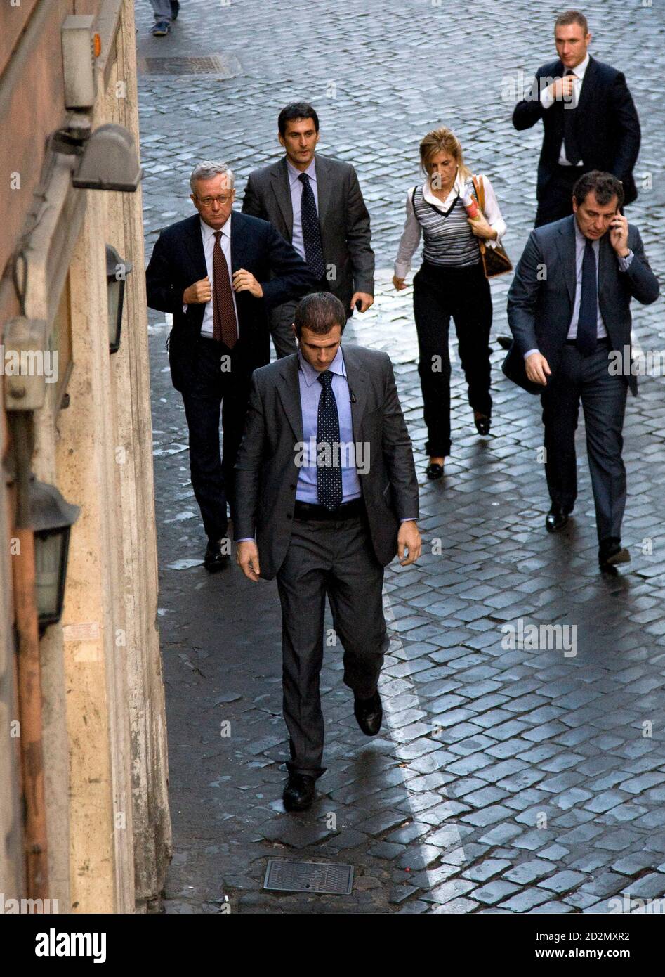 Italy's Economy Minister Giulio Tremonti (L) arrives with staff for a news conference at the Foreign Press Association in Rome October 16, 2008. Tremonti said on Thursday that the global financial and banking crisis had been overcome but persisting pessimism on markets reflected fear about the 'real' economy. REUTERS/Alessandro Bianchi        (ITALY) Stock Photo