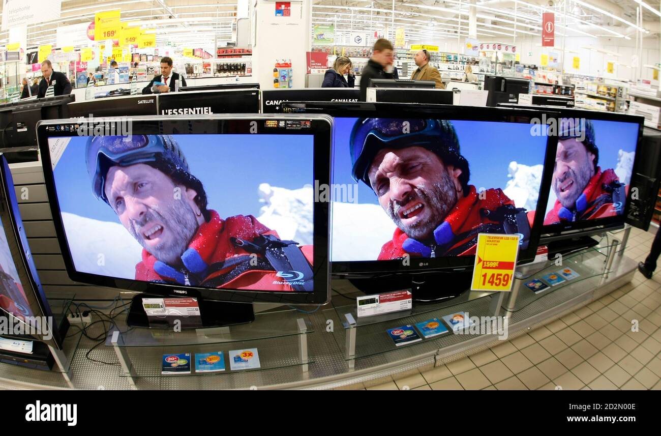 Shoppers look at television screens in a Carrefour supermarket in Antibes,  southeastern France, March 23, 2009. REUTERS/Eric Gaillard (FRANCE BUSINESS  FOOD DRINK Stock Photo - Alamy