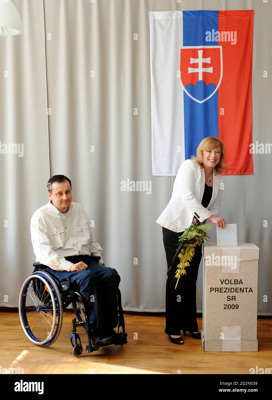 Slovakian presidential candidate Iveta Radicova (R) and her partner Jan  Riapos cast ballots at a polling station during the run-off presidential  elections in the village of Nova Dedinka, about 20 km (12