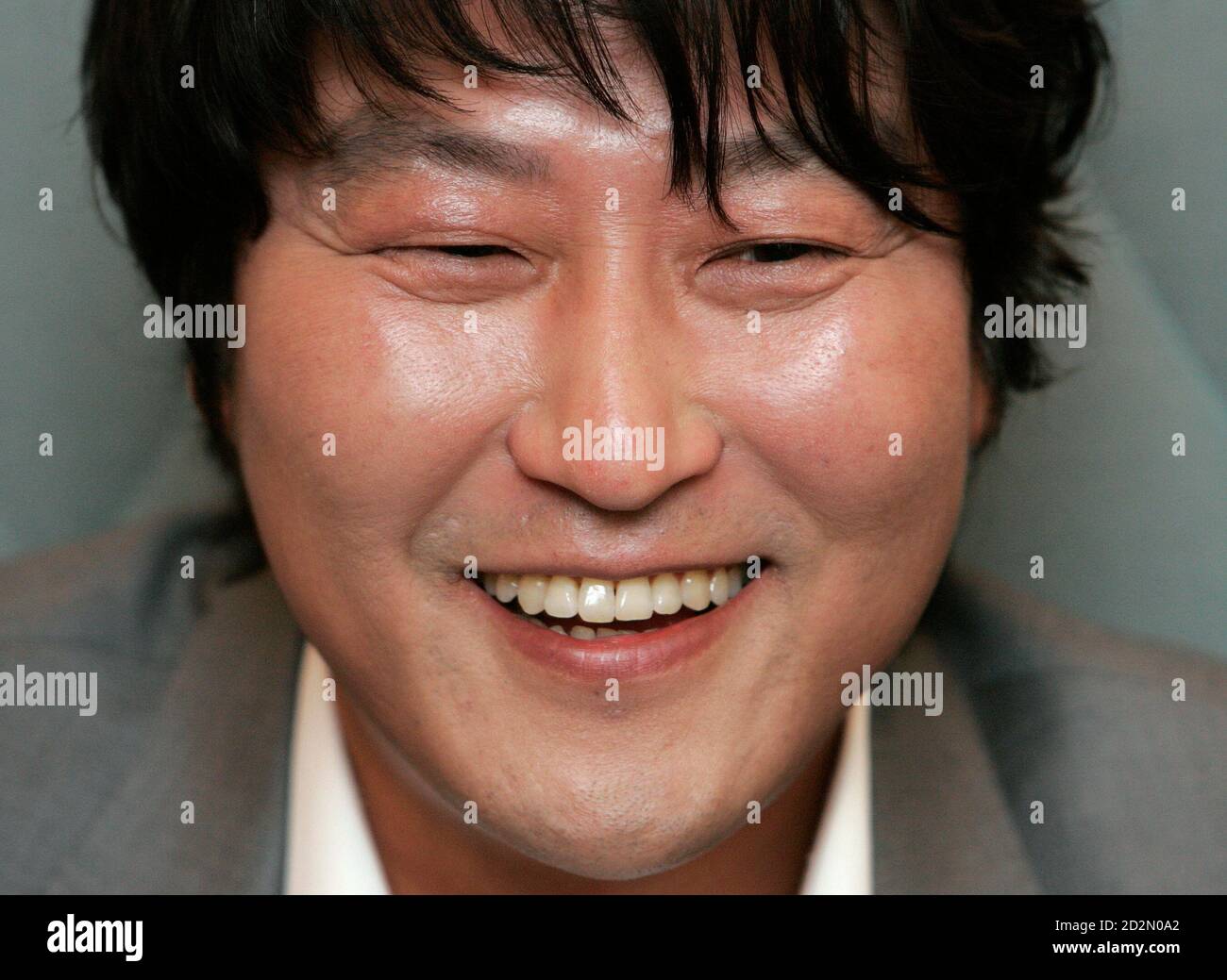 South Korean movie actor Song Kang-ho smiles during an interview with Reuters regarding his new movie 'Thirst', one of the 62nd Cannes Film Festival nominees, in Seoul May 4, 2009. One of South Korea's most bankable stars will return to the red carpet of the Cannes International Film Festival next week with a blood-soaked morality tale of a Catholic priest turned vampire. Picture taken May 4, 2009.  REUTERS/Jo Yong-Hak (SOUTH KOREA ENTERTAINMENT HEADSHOT SOCIETY) Stock Photo
