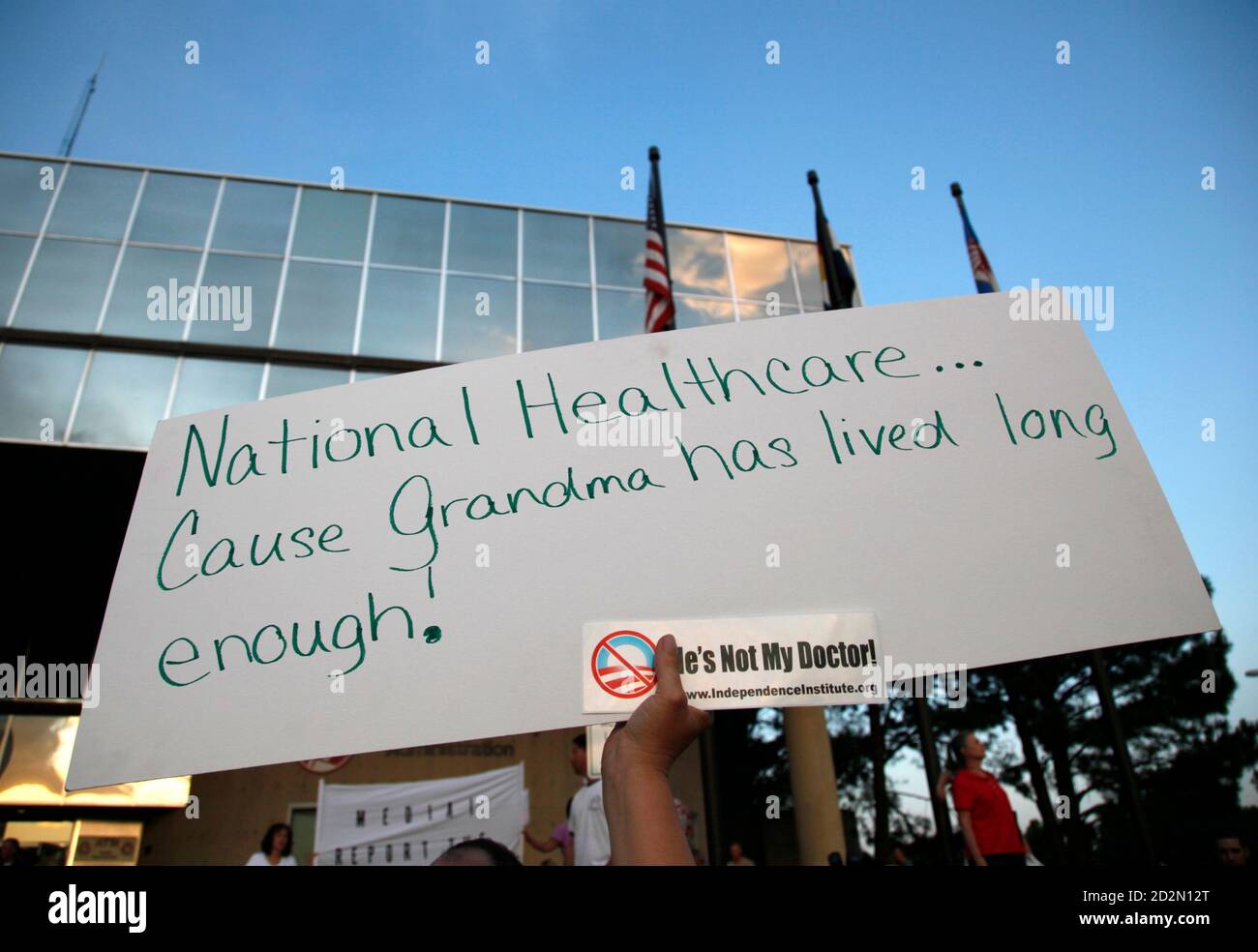 A demonstrator holds up a sign outside a town hall meeting on healthcare reform hosted by Rep. Mike Coffman (R-CO) in Littleton, Colorado August 12, 2009. REUTERS/Rick Wilking (UNITED STATES POLITICS HEALTH) Stock Photo