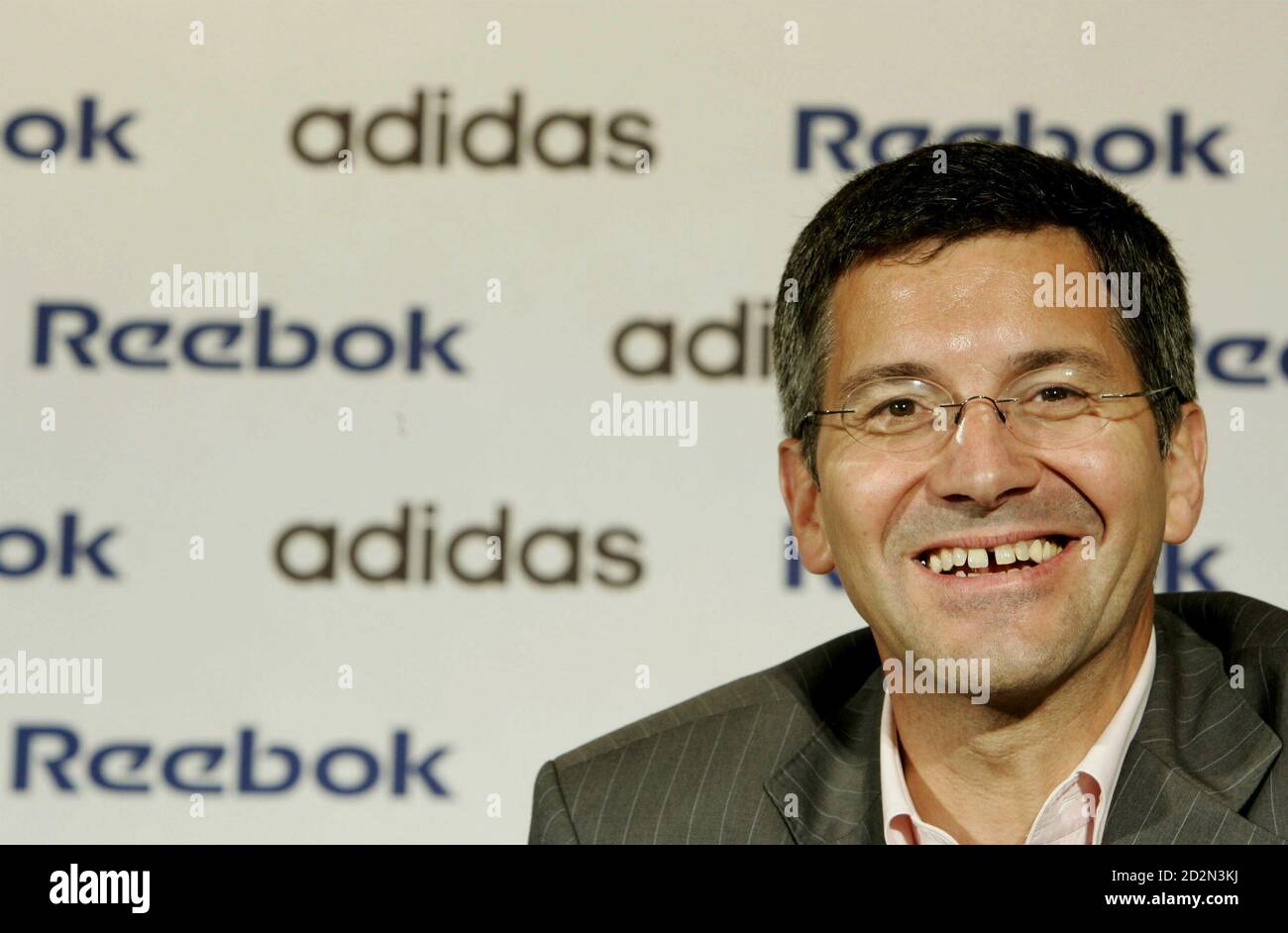 Herbert Hainer, chairman and chief executive of Adidas-Salomon, attends a  news conference with Paul Fireman, chairman and chief executive of Reebok,  at Reebok's world headquarters in Canton, Massachusetts August 9, 2005.  [Germany's