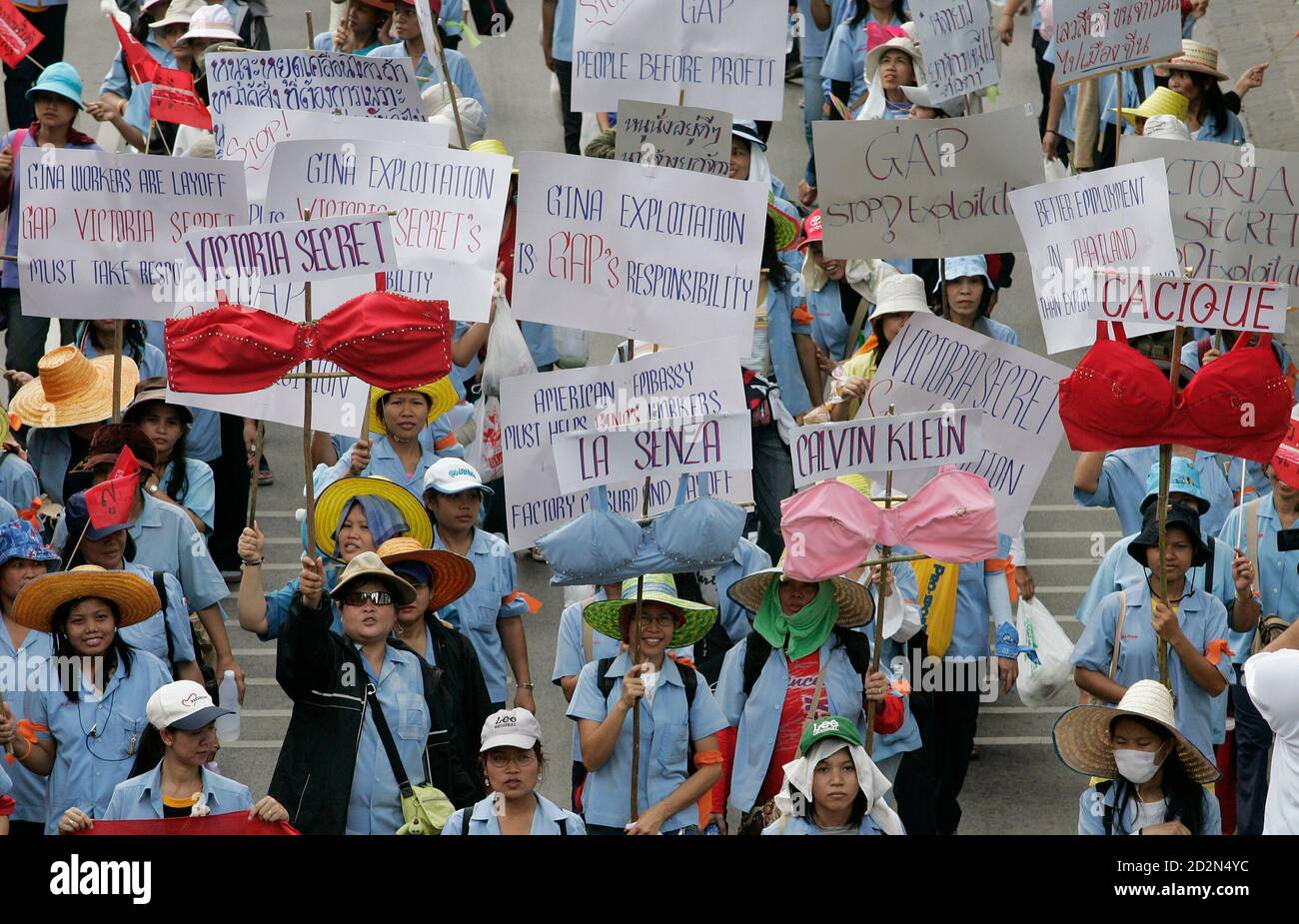 Thai demonstrators hold banners and bra during a protest outside the U.S.  embassy in Bangkok October 8, 2006. Some 800 workers submitted a letter to  the U.S. ambassador in which they urged