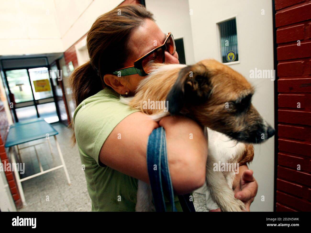 A woman cries after finding her dog in the Society for the Prevention of Cruelty to Animals in Santiago, February 28, 2007. Animal rights activists say abuse of dogs is common across A woman cries after finding her dog in the Society for the Prevention of Cruelty to Animals in Santiago, February 28, 2007. Animal rights activists say abuse of dogs is common across