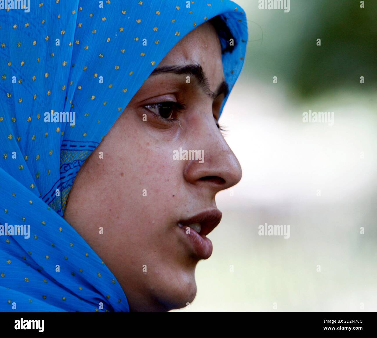 A Kashmiri Muslim cries while narrating the tale about her 'missing' father during a peaceful demonstration organised by the Association of Parents of Disappeared Persons (APDP) to mark the International Day of the Disappeared in Srinagar August 30, 2007. The APDP says that more than 8000 people have gone missing, most of them after their arrest by Indian security forces in the troubled Kashmir region since a rebellion broke out at the end of 1989. REUTERS/Fayaz Kabli (INDIAN-ADMINISTERED KASHMIR) Stock Photo