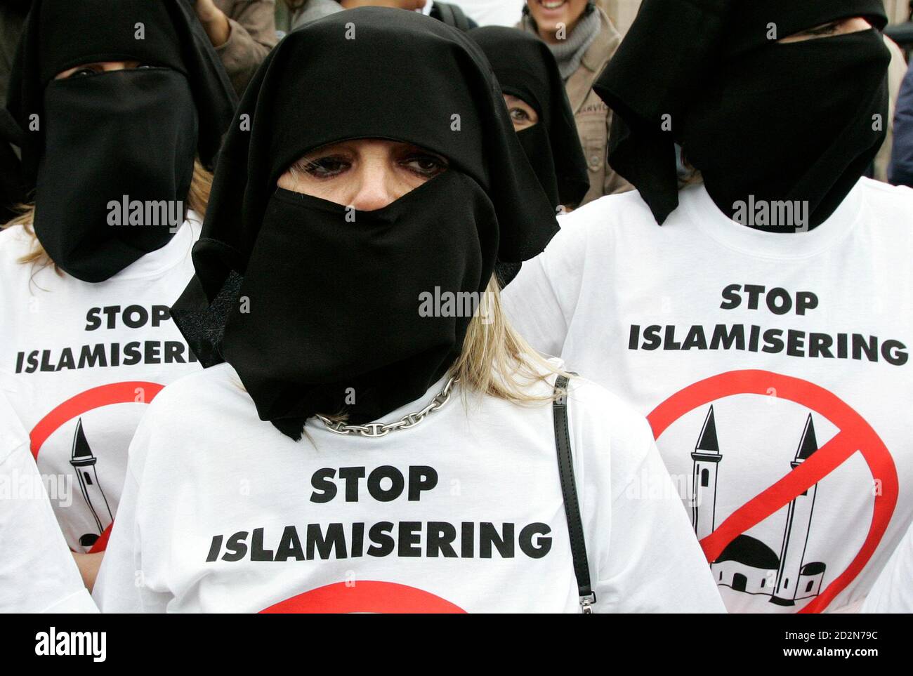 Supporters of the Belgium's far-right party Vlaams Belang wear mock-Muslim  scarves and tee-shirts reading "Stop Islamisation" during a banned  demonstration organised by a group called "Stop the Islamisation of Europe"  in Brussels