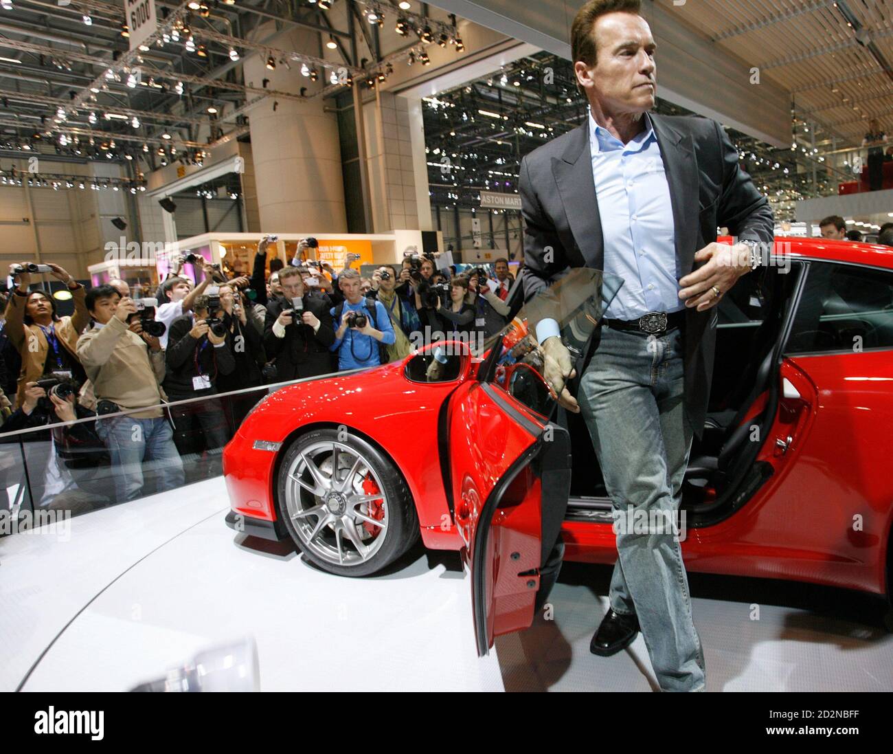 California Governor Arnold Schwarzenegger gets out of a GT3 Porsche during  the second media day of the 79th Geneva Car Show at the Palexpo in Geneva  March 4, 2009. REUTERS/Denis Balibouse (SWITZERLAND