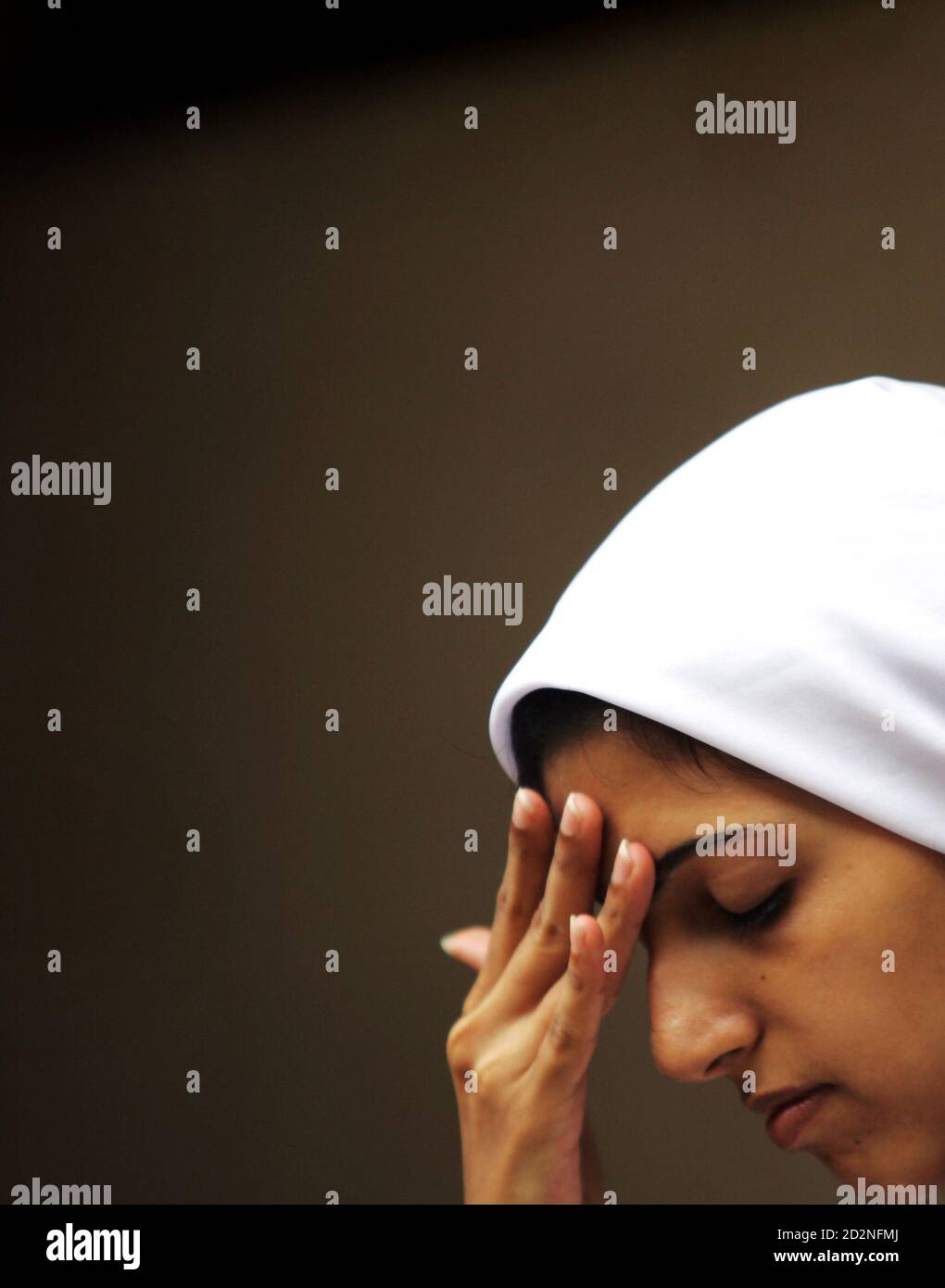 A girl prays at a Parsi temple on the Parsi New Year in Mumbai August 20, 2005. Followers of the Persian prophet Zarathustra, the Parsi community arrived in western India 1200 years ago after they fled Persia following persecution from Arab conquerors. REUTERS/Punit Paranjpe AD/NL Stock Photo