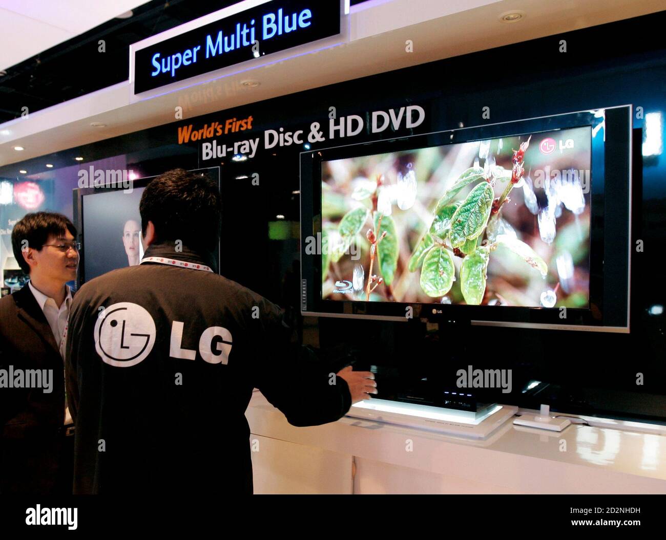 LG employees look at the new LG Super Multi Blue player at the LG booth  before the 2007 International Consumer Electronics Show (CES) in Las Vegas,  Nevada January 7, 2007. The single