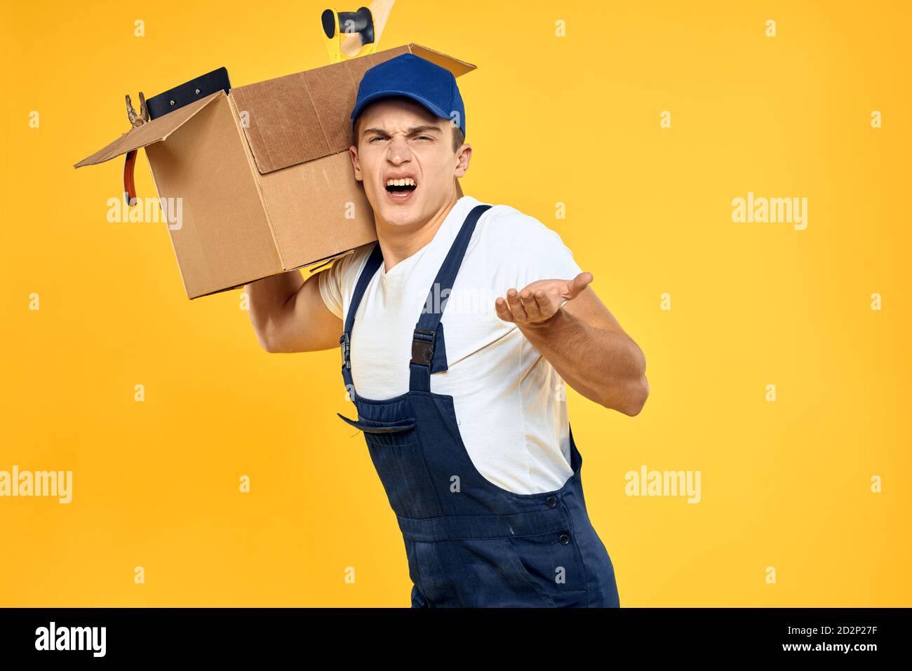 Working man in uniform with box hand delivery loading service yellow ...