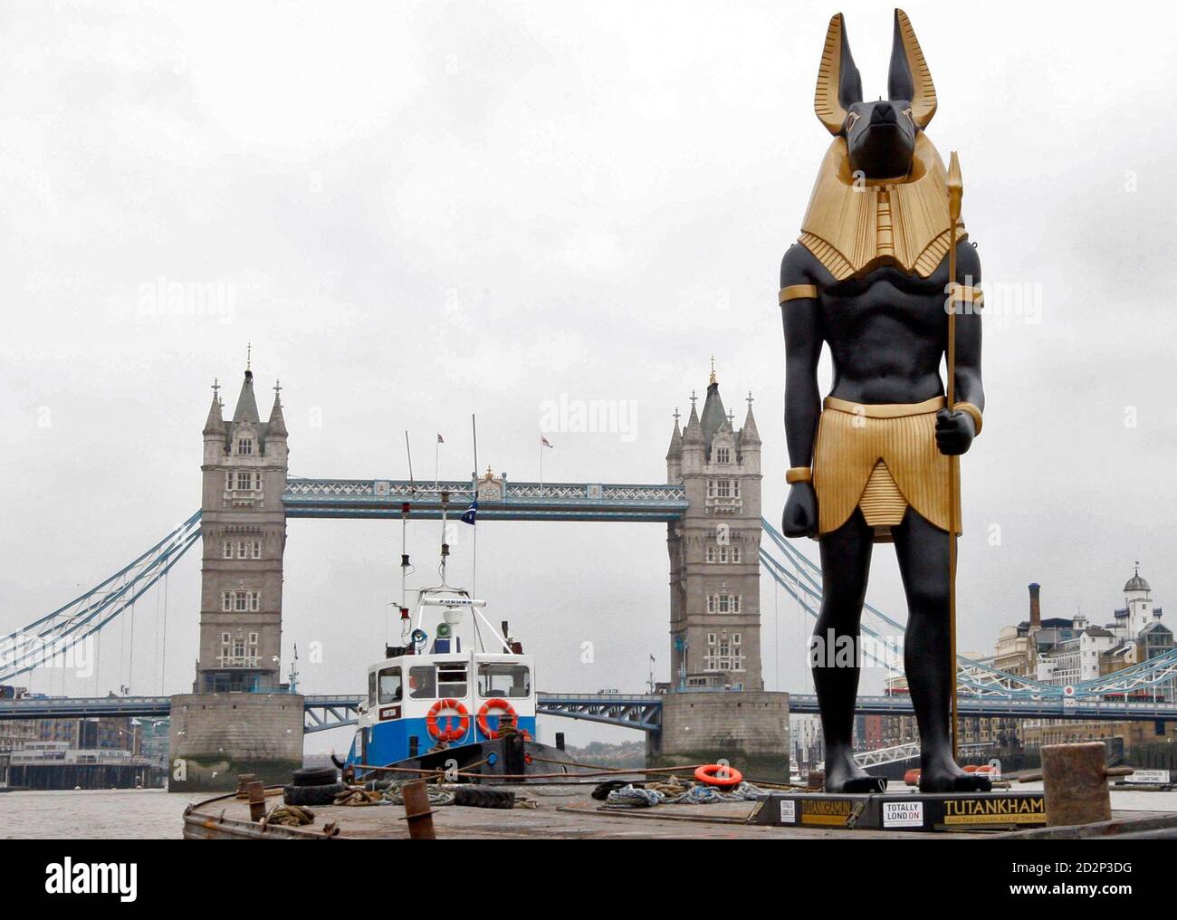 A 25ft (7.62 meters) replica of the Golden Anubis, an ancient Egyptian  jackal-headed god of the dead, sails away fromTower Bridge on the river  Thames, to take up a position in Trafalgar