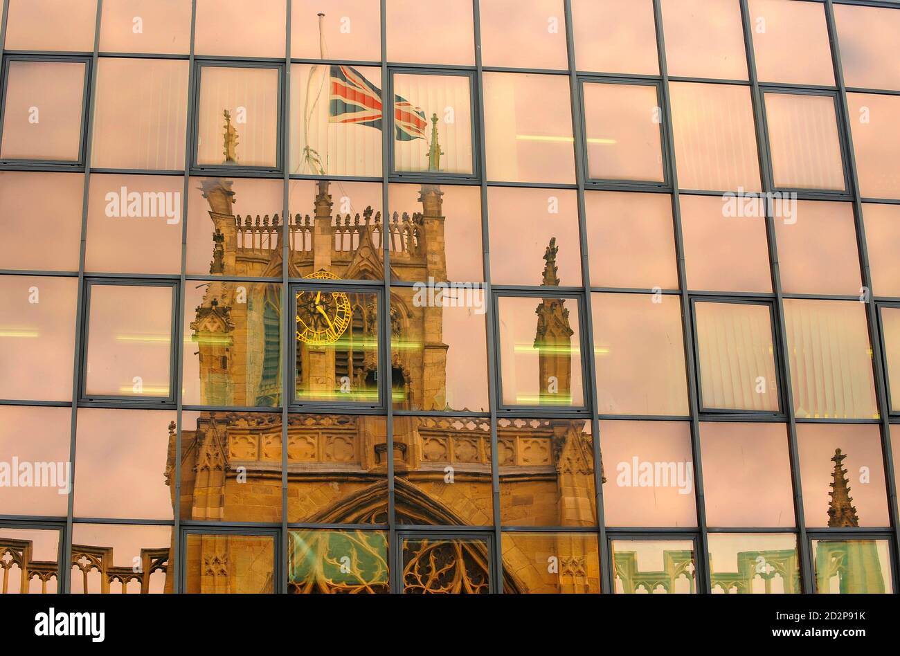 A reflection in the windows of a building shows the Union flag at half mast above Holy Trinity Church before the funeral of Private Johnathon Young of the 3rd Battalion The Yorkshire Regiment (Duke of Wellington's) in Hull, northern England September 16, 2009.  Private Young died in an explosion while on foot patrol in Helmand province, Afghanistan, on August 20.    REUTERS/Nigel Roddis (BRITAIN OBITUARY CONFLICT) Stock Photo