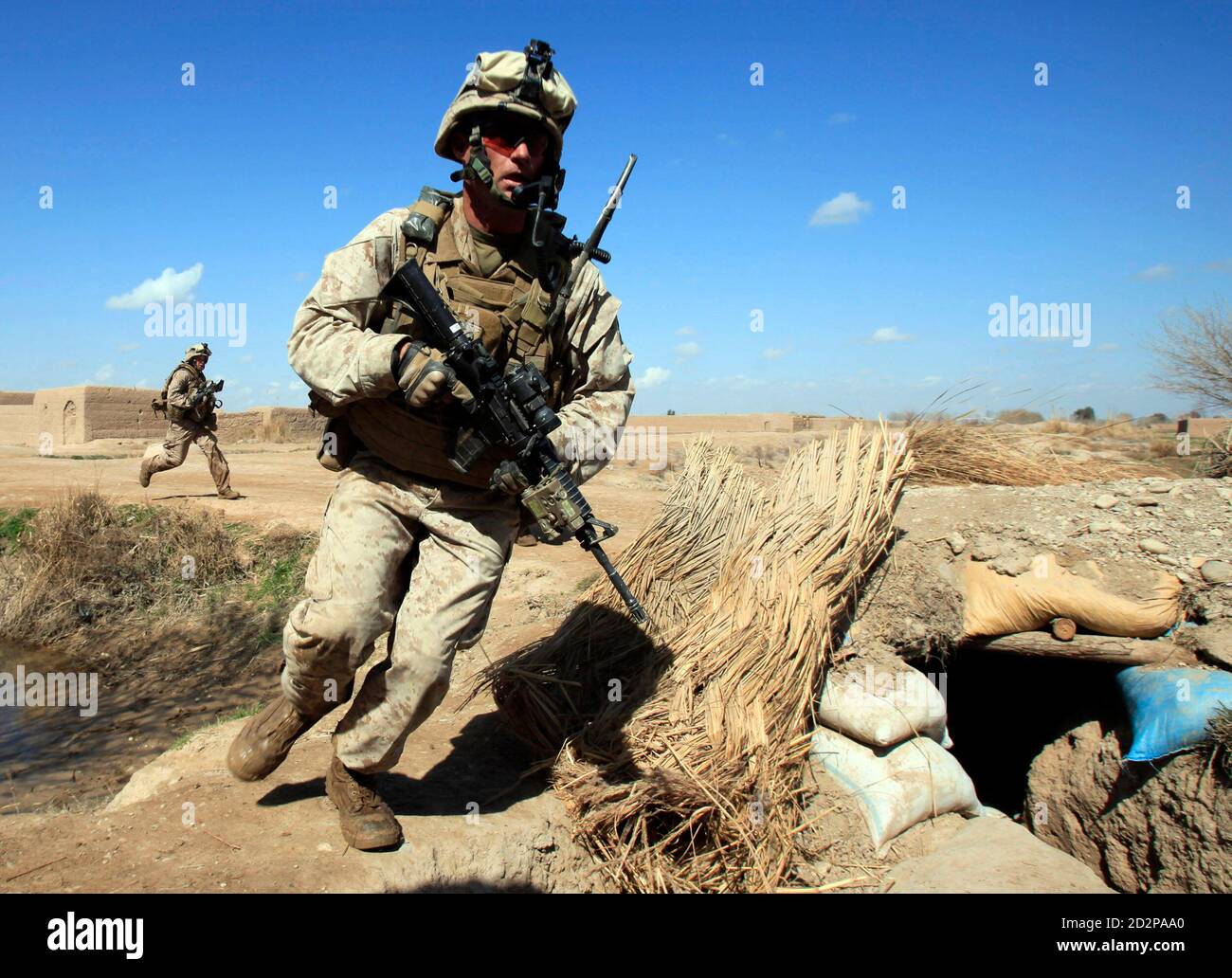 U.S. Marines from Bravo Company of the1st Battalion, 6th Marines run during a battle in Marjah, Helmand province February 22, 2010.   REUTERS/Goran Tomasevic  (AFGHANISTAN - Tags: MILITARY CONFLICT) Stock Photo