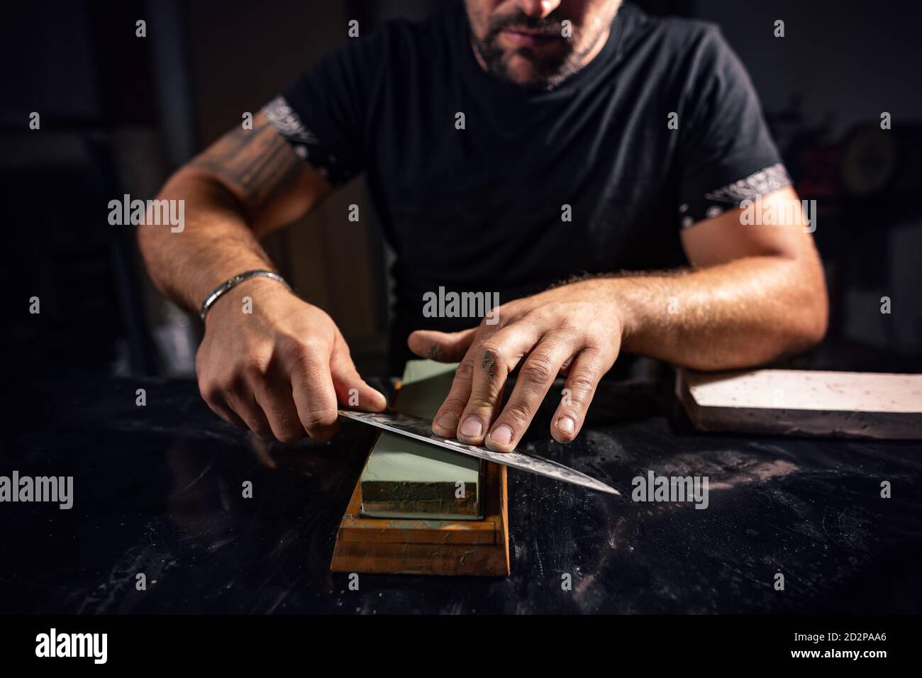 The man using whetstone to sharpening chef knife Stock Photo