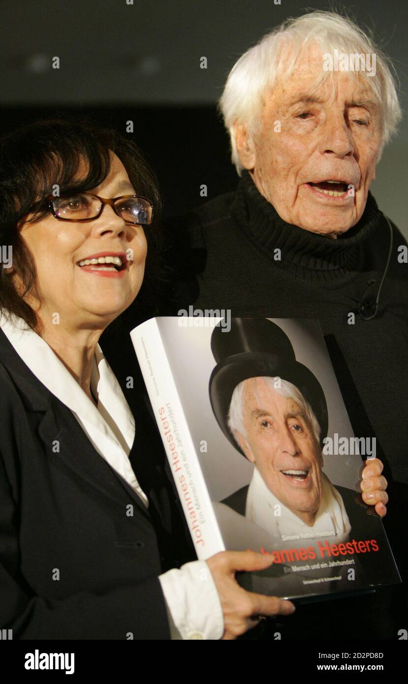 Dutch-born 102-year-old German actor and singer Johannes Heesters (R) and his wife Simone Rethel-Heesters pose for media during the presentation of his autobiography 'Johannes Heesters - Ein Mensch und ein Jahrhundert' (A Man and a Century) in Berlin November 13, 2006. The book written by his wife was presented on Monday in the German capital.      REUTERS/Tobias Schwarz     (GERMANY) Stock Photo