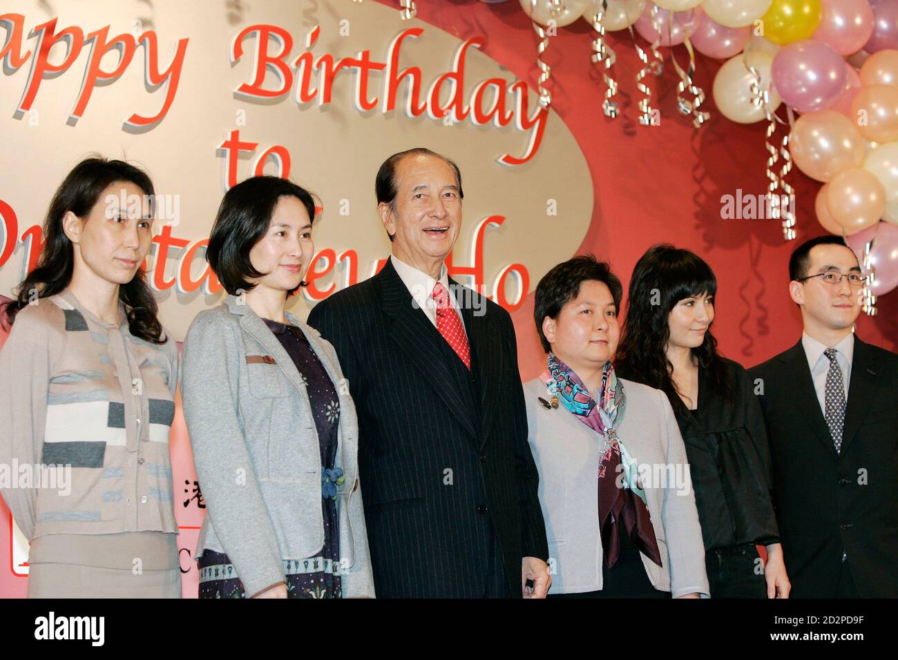 Macau tycoon Stanley Ho (3rd L) celebrates his 85th birthday with his daughters Daisy (L), Pansy (2nd L), Maisy (3rd R), Josie (2nd R) and son Lawrence during a ceremony in which he donated HK$2.5 million ($320,510) to a charity in Hong Kong November 20, 2006.    REUTERS/Bobby Yip  (CHINA) Stock Photo