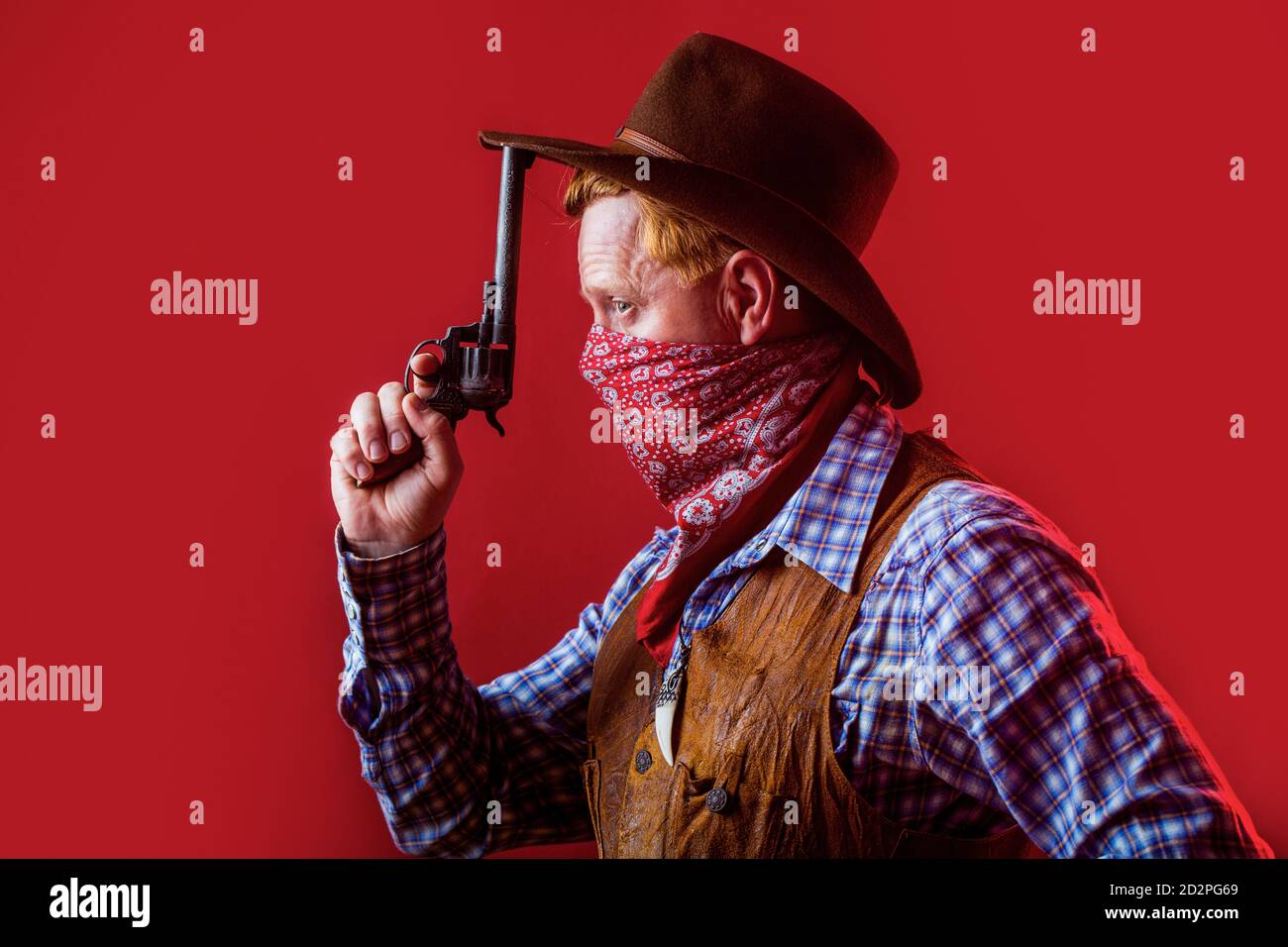 Portrait of man wearing cowboy hat, gun. Portrait of a cowboy. West, guns. Portrait of a cowboy