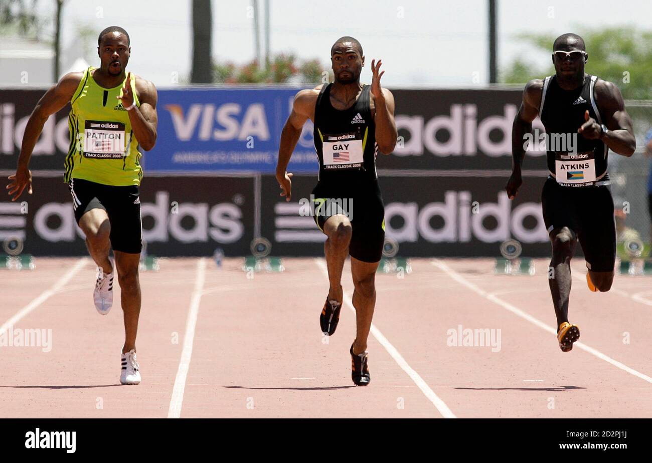 Tyson Gay (C) of the U.S. runs on his way to winning the men's 100 meter  dash during the Adidas Track Classic in Carson, California May 18, 2008.  Compatriot Darvis Patton (L)