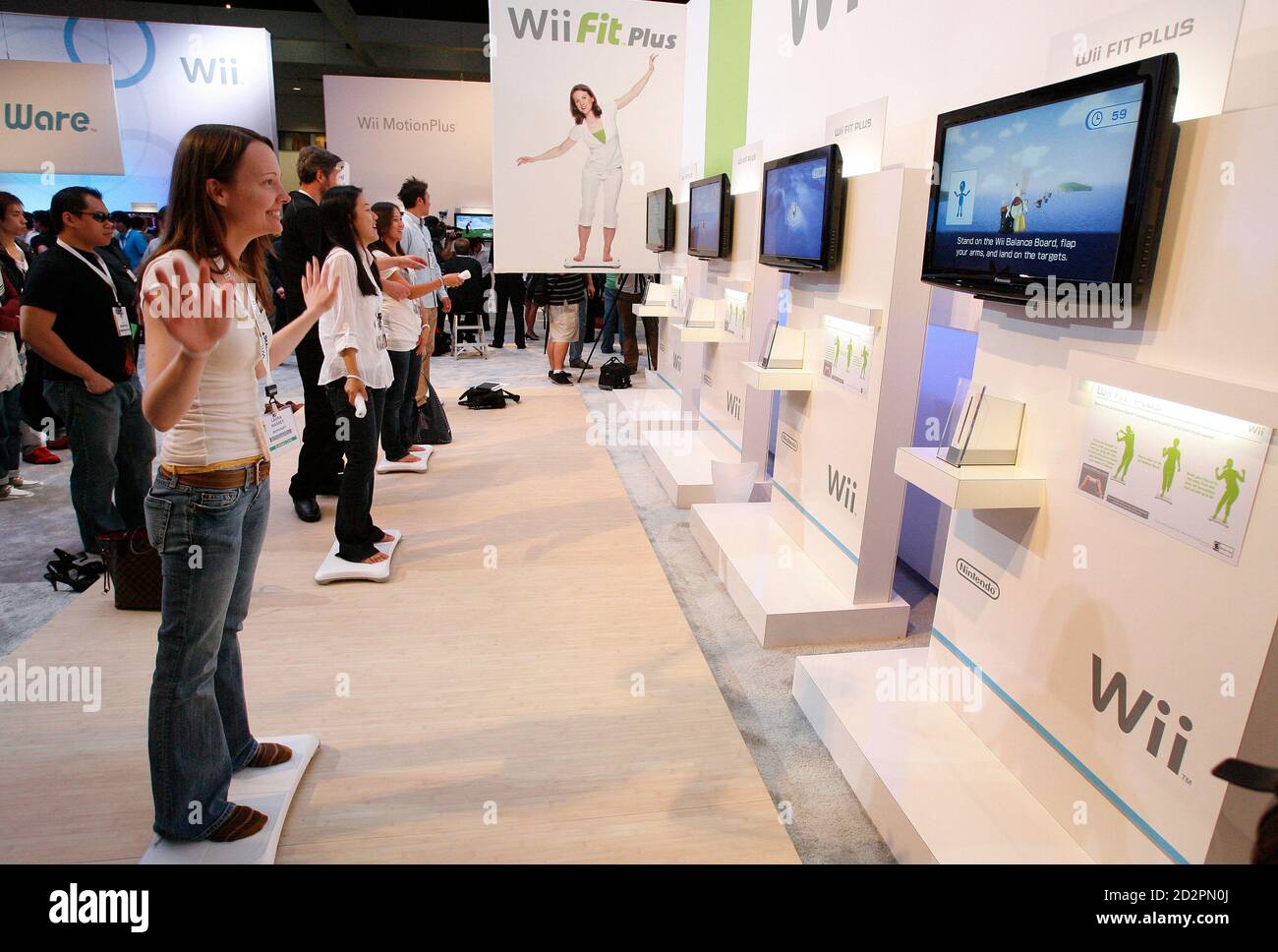 Visitors step on Nintendo Wii Balance Boards as they play the new Wii Fit  Plus game during the Electronic Entertainment Expo or E3 in Los Angeles  June 2, 2009. REUTERS/Mario Anzuoni (UNITED