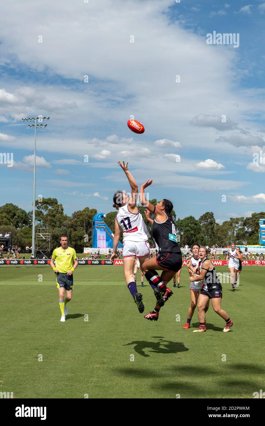Women compete in the ruck during a game in the Women's Australian Football League. Stock Photo