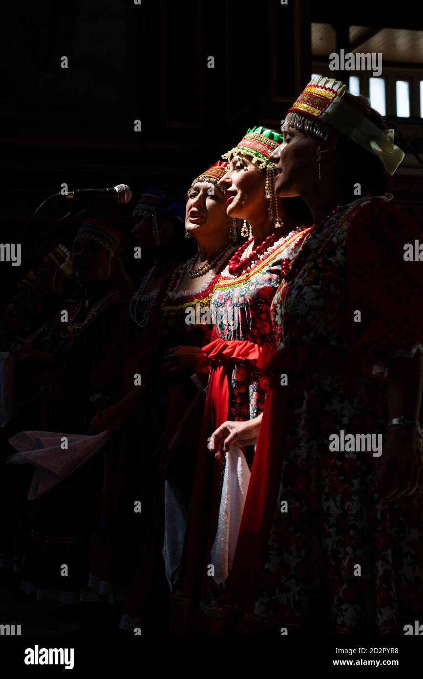 Three women in traditional dress sing at the Melbourne Russian Festival. Stock Photo