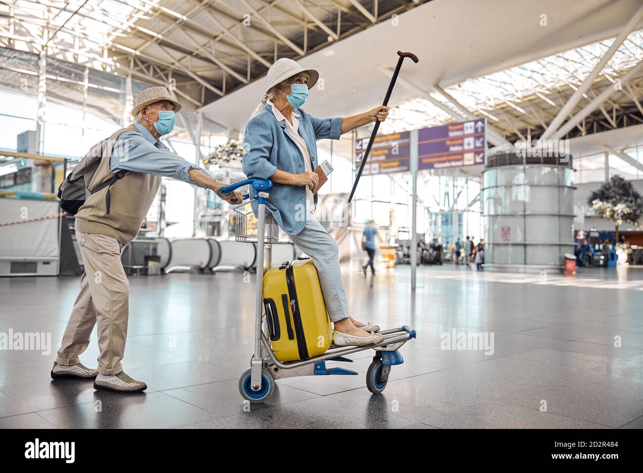 Woman enjoying her ride on a baggage cart Stock Photo Alamy