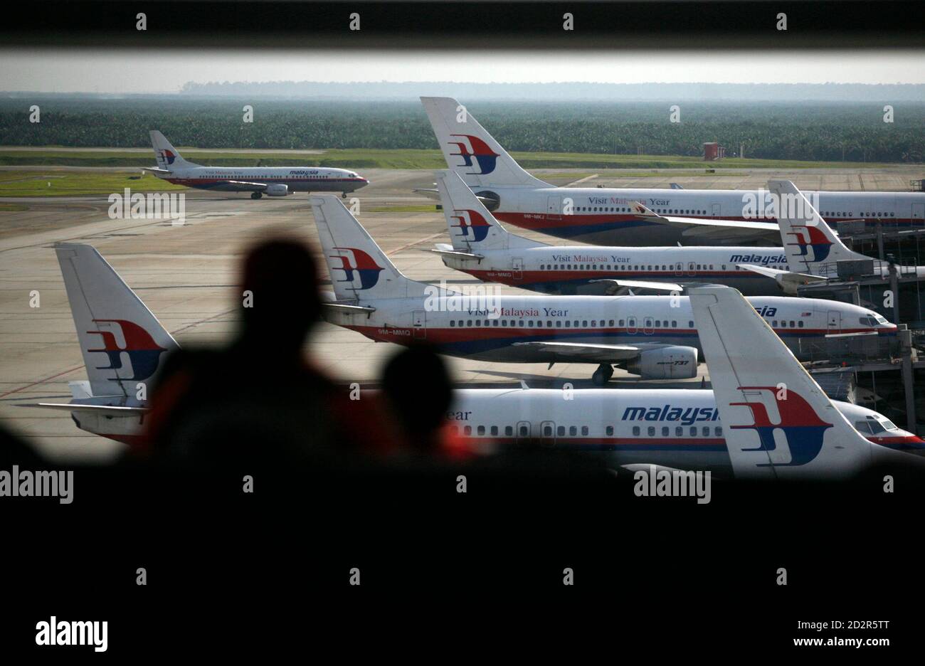 Passengers Watch Malaysia Airline System Aircrafts As They Wait For Their Connecting Flights At A Viewing Gallery In Kuala Lumpur International Airport In Sepang August 6 2009 Malaysia Airlines Reversed Losses That