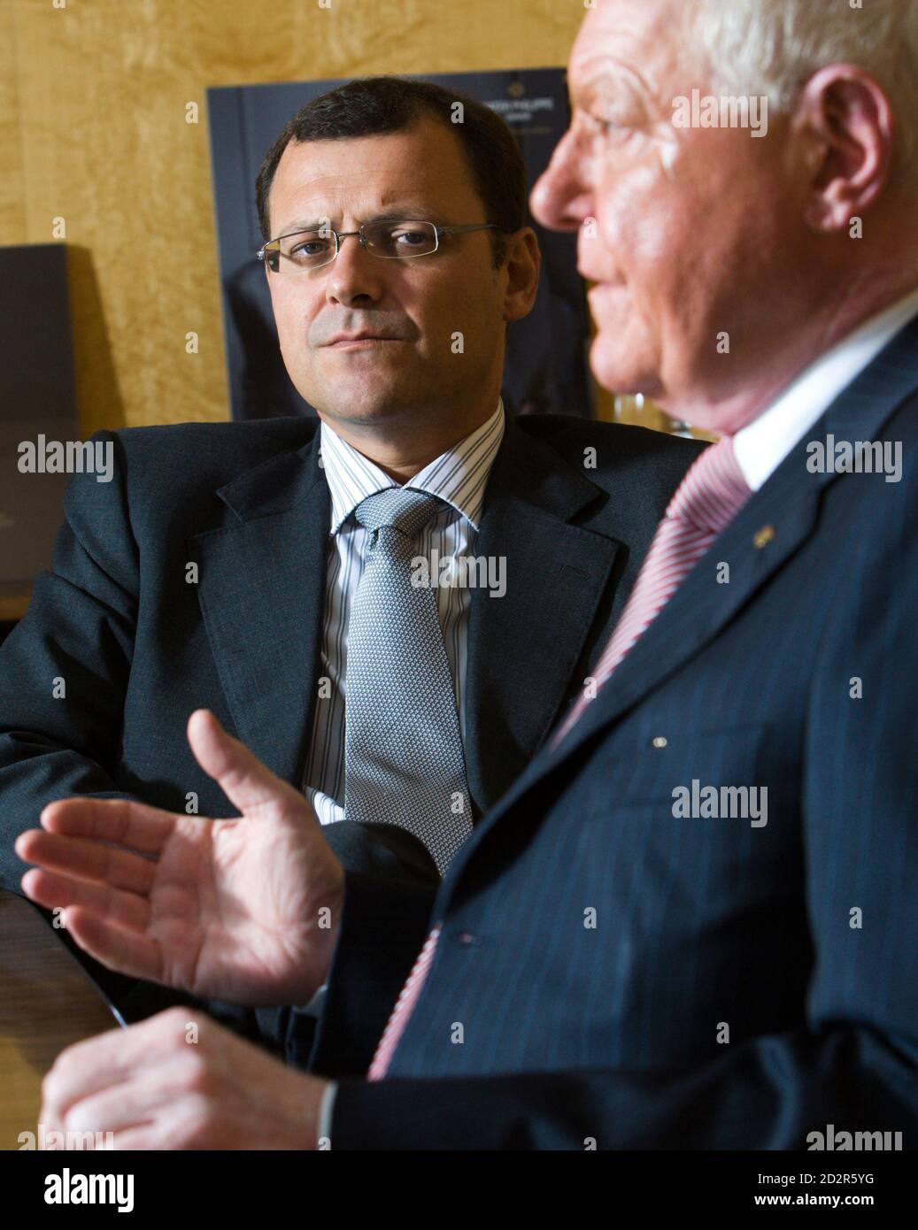 Thierry Stern (L) Vice-President listens to his father Philippe Stern,  President of Patek Philippe during an interview with Reuters at the Swiss  watchmaker manufacture in Plan-Les-Ouates near Geneva August 17, 2009. Patek