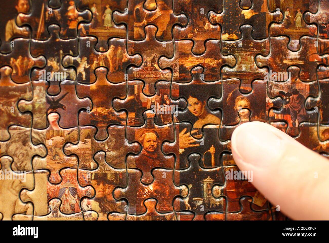 A staff of Japanese puzzle maker Beverly points at a piece of a new jigsaw  puzzle "Mona Lisa" displayed at the International Tokyo Toy Show 2009 in  Tokyo July 16, 2009. "Mona
