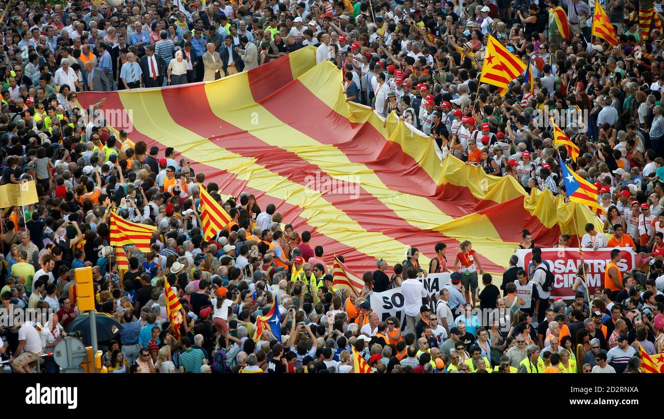 People take to the streets with a huge Catalan flag during a protest for  greater autonomy for Catalonia within Spain in central Barcelona, July 10,  2010. More than a million people took