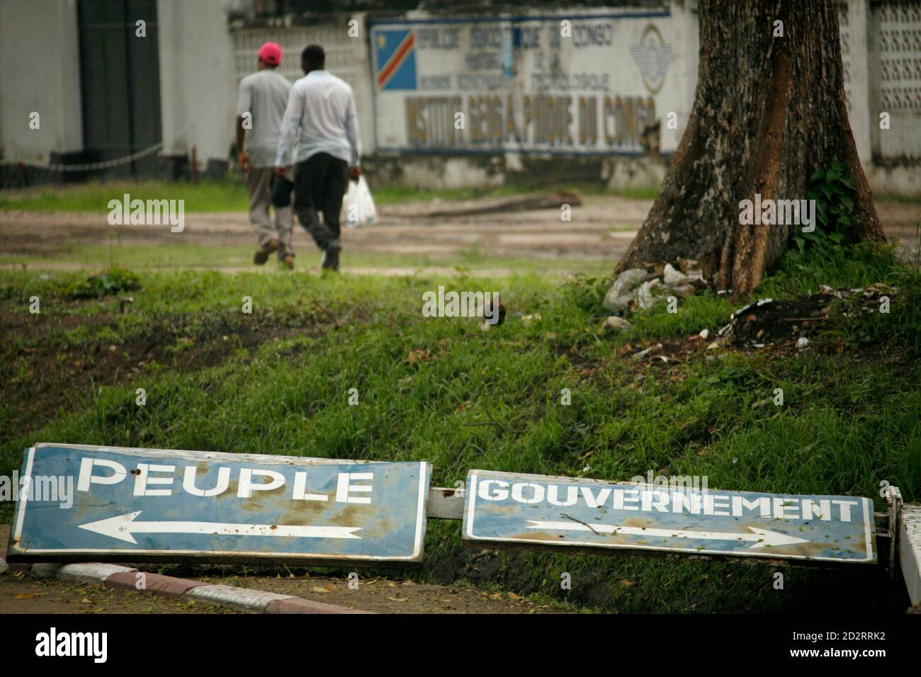 Congolese Civilians Walk Past A Broken Road Sign In Kinshasa November 17 2006 The Road Signs Read People L And Government President Joseph Kabila Won A Historic Run Off Vote This Week But