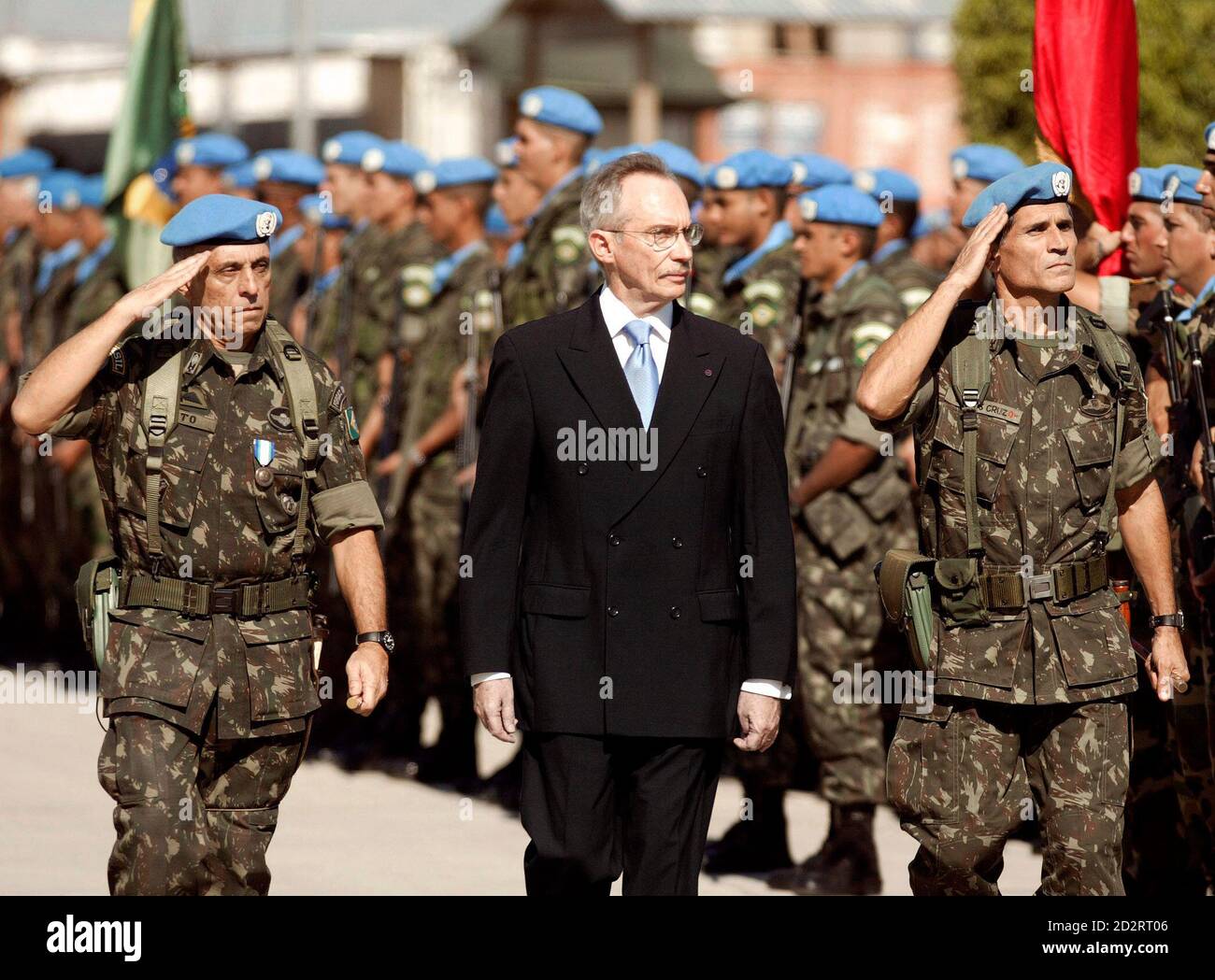 U.N. envoy to Haiti Edmond Mulet (C) walks with the new commander for the  U.N. peacekeeping mission In Haiti Brazilian Maj. Gen. Carlos Alberto Dos  Santos Cruz (R) and former U.N. commander