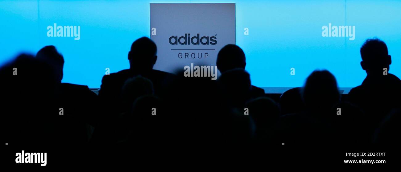 Shareholders are silhouetted before the annual shareholder meeting of the  Adidas Group in Fuerth May 10, 2007. REUTERS/Michaela Rehle (GERMANY Stock  Photo - Alamy