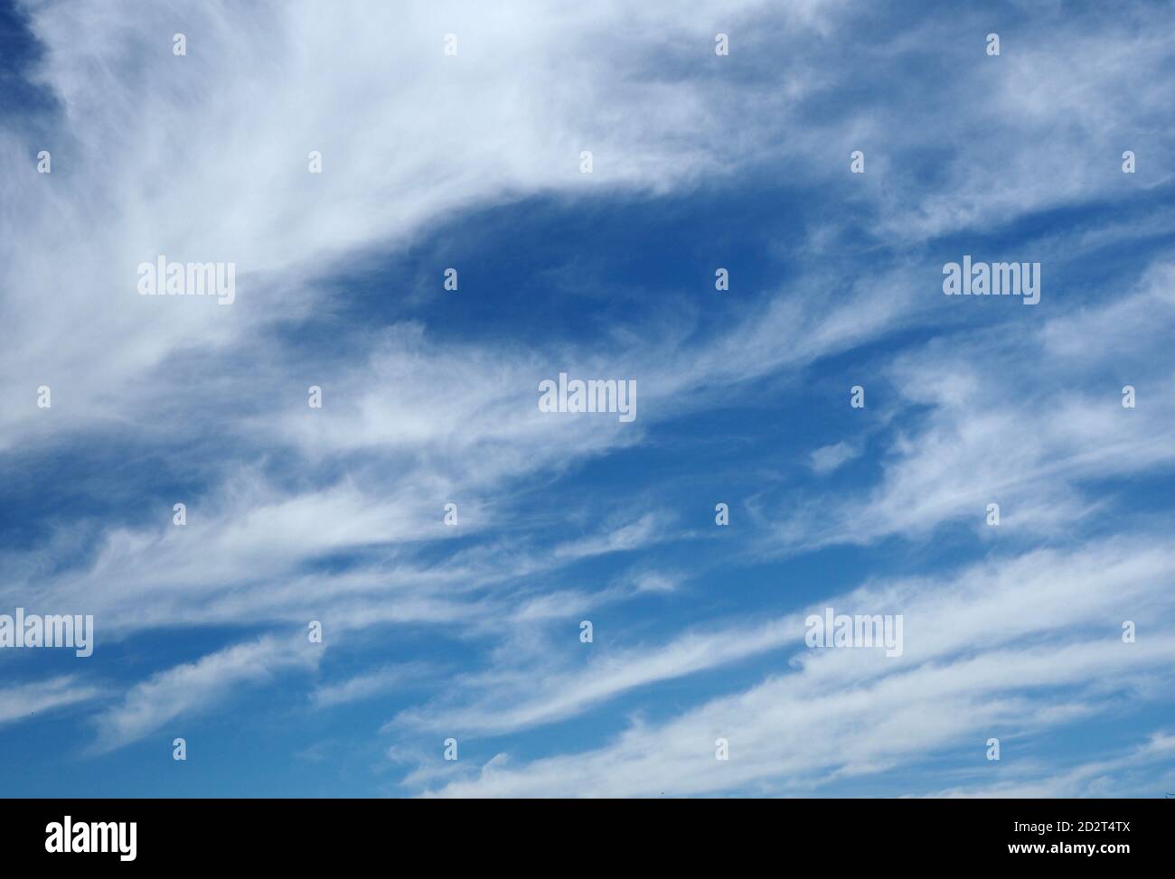 Wispy cirrus clouds against a blue sky Stock Photo - Alamy