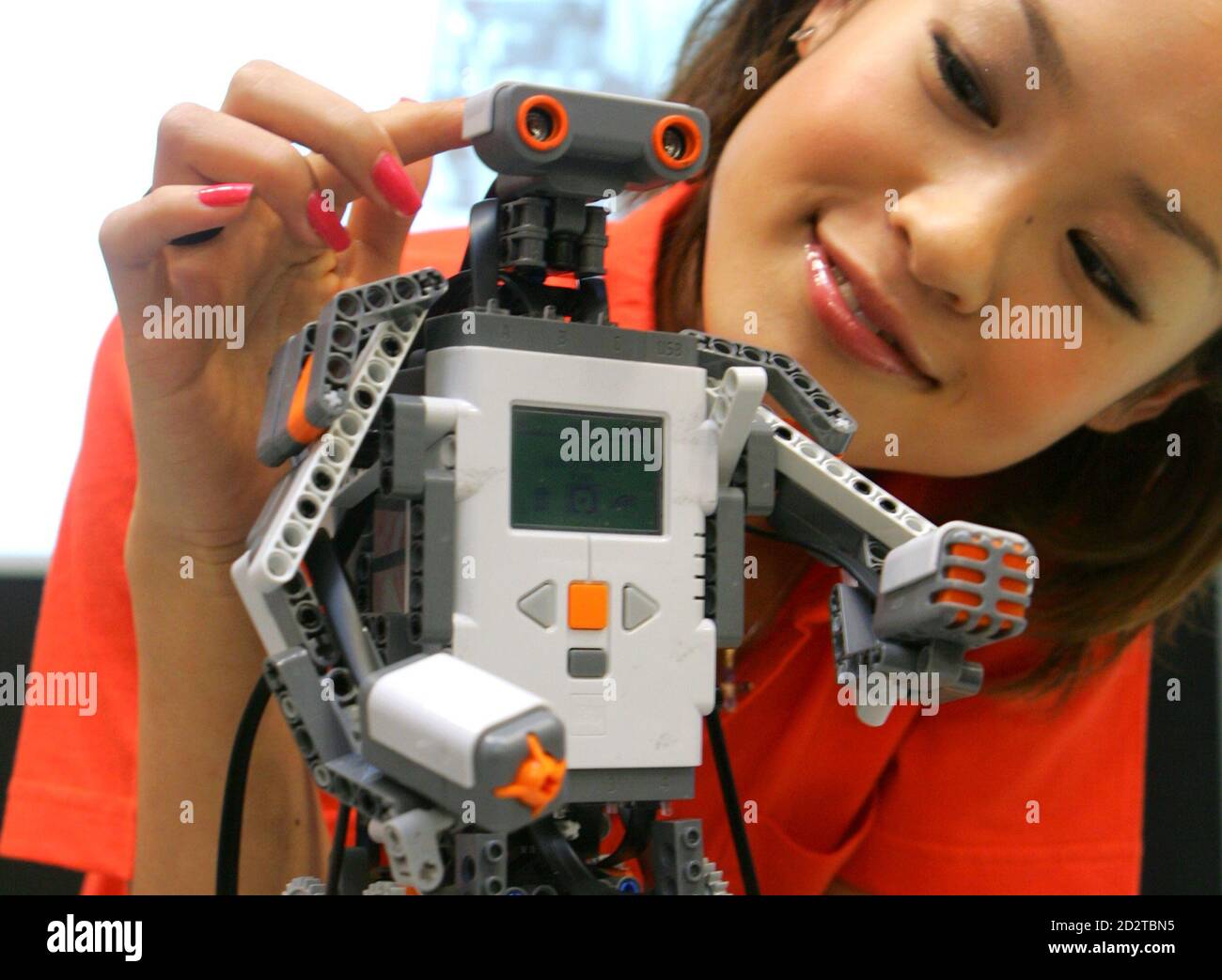 Japanese model Akiko Fukuda presents Lego Group's new educational robot " LEGO MINDSTORMS NXT", equipped with a 32-bit microprocessor, USB 2.0, and  Bluetooth during a press preview in Tokyo in this June 6,