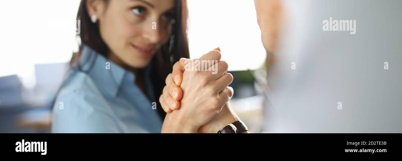 Businesswoman is competing in her arms with man. Stock Photo