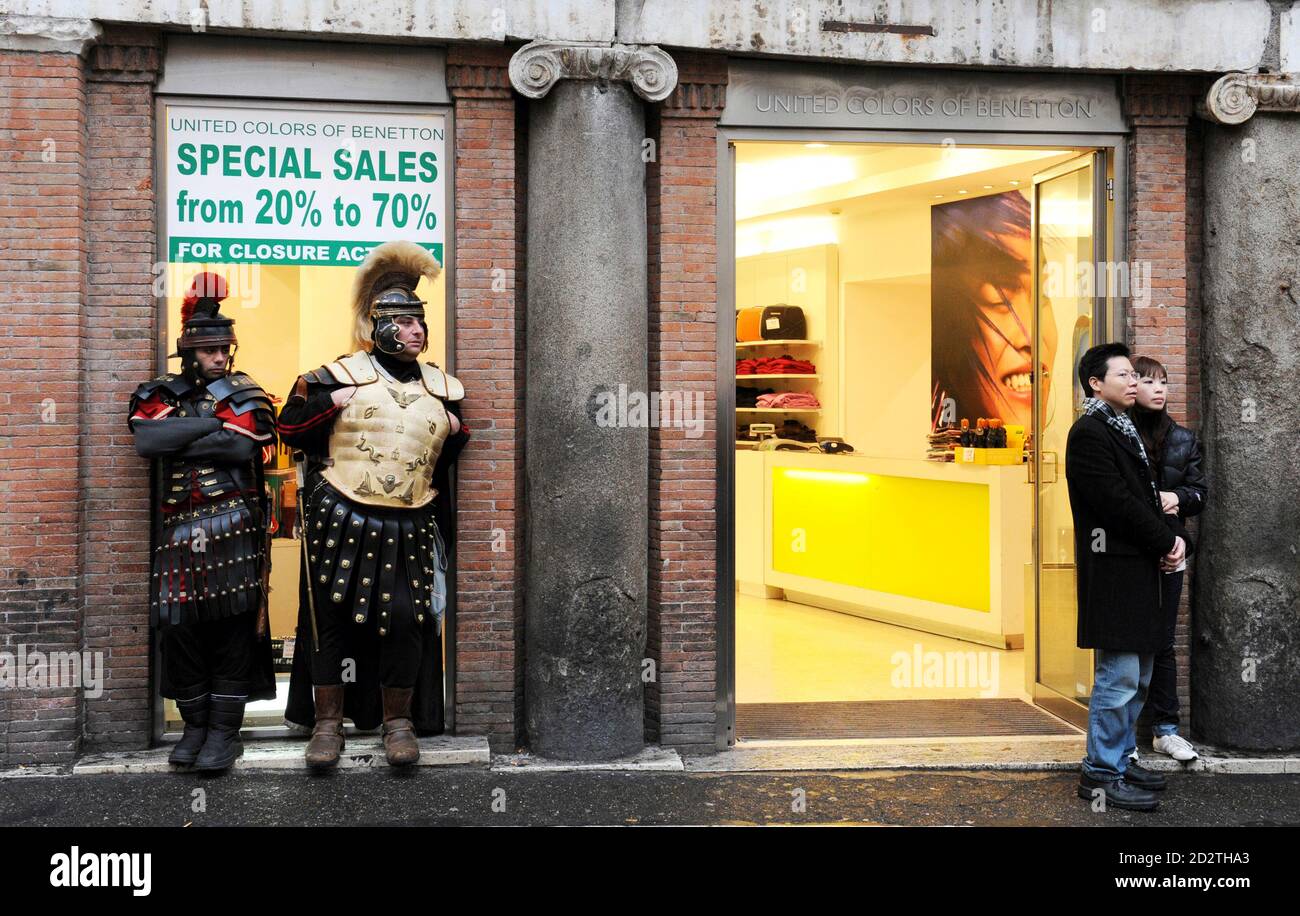Two men dressed up as centurions look a couple tourists in front of a shop, offering discounted goods, in downtown Rome January 5, 2010.   REUTERS/Alessandro Bianchi   (ITALY - Tags: BUSINESS TRAVEL IMAGES OF THE DAY) Stock Photo