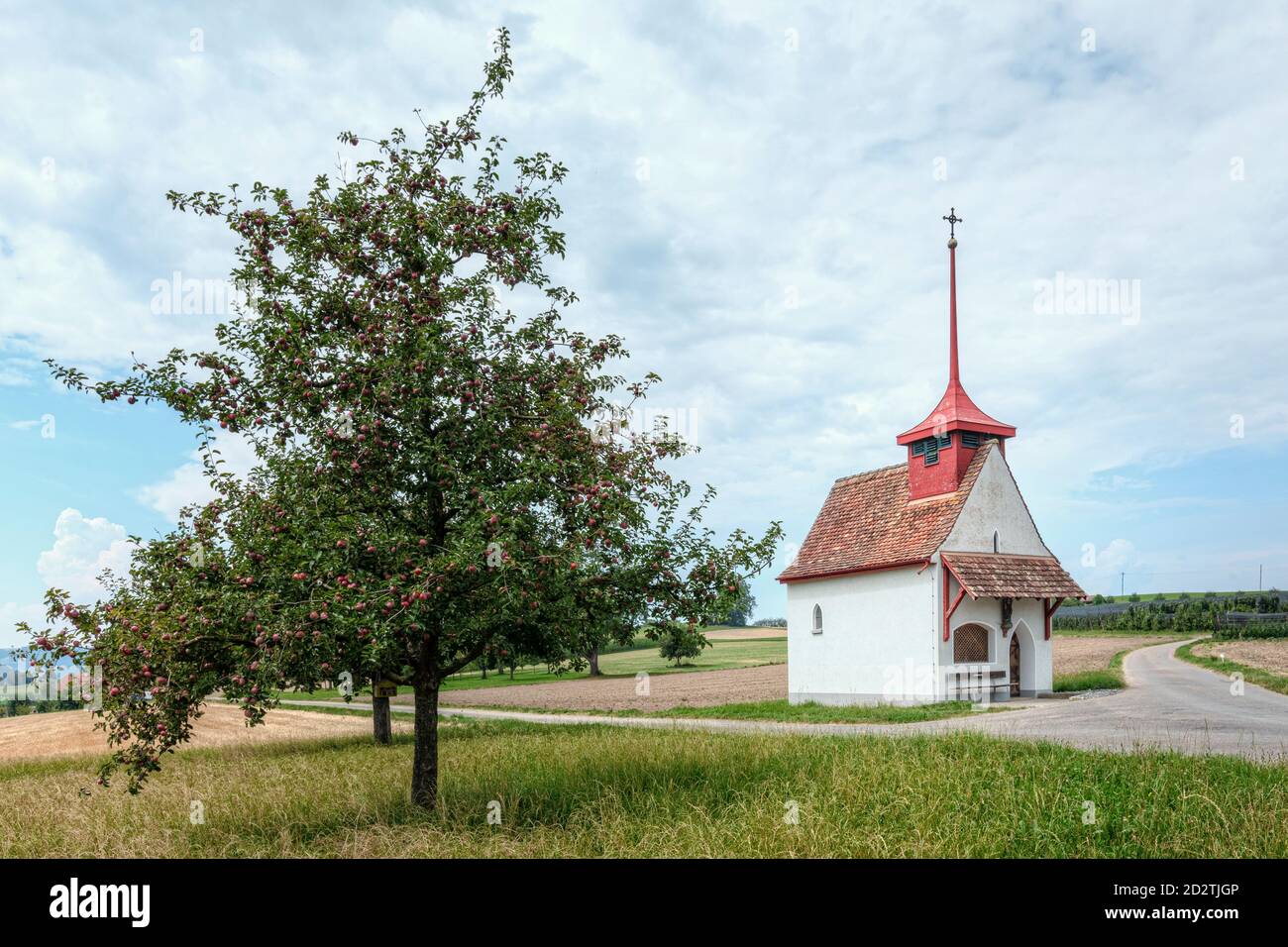 a chapel with red roof on rural fields Stock Photo