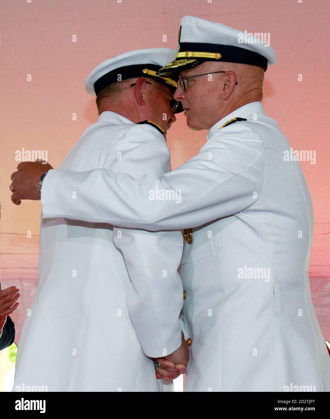 New Commandant of the U.S. Coast Guard Admiral Robert J. Papp, Jr. (R) hugs his predecessor Admiral Thad W. Allen during a Change of Command ceremony in Washington May 25, 2010.  REUTERS/Jim Young   (UNITED STATES - Tags: POLITICS MILITARY) Stock Photo